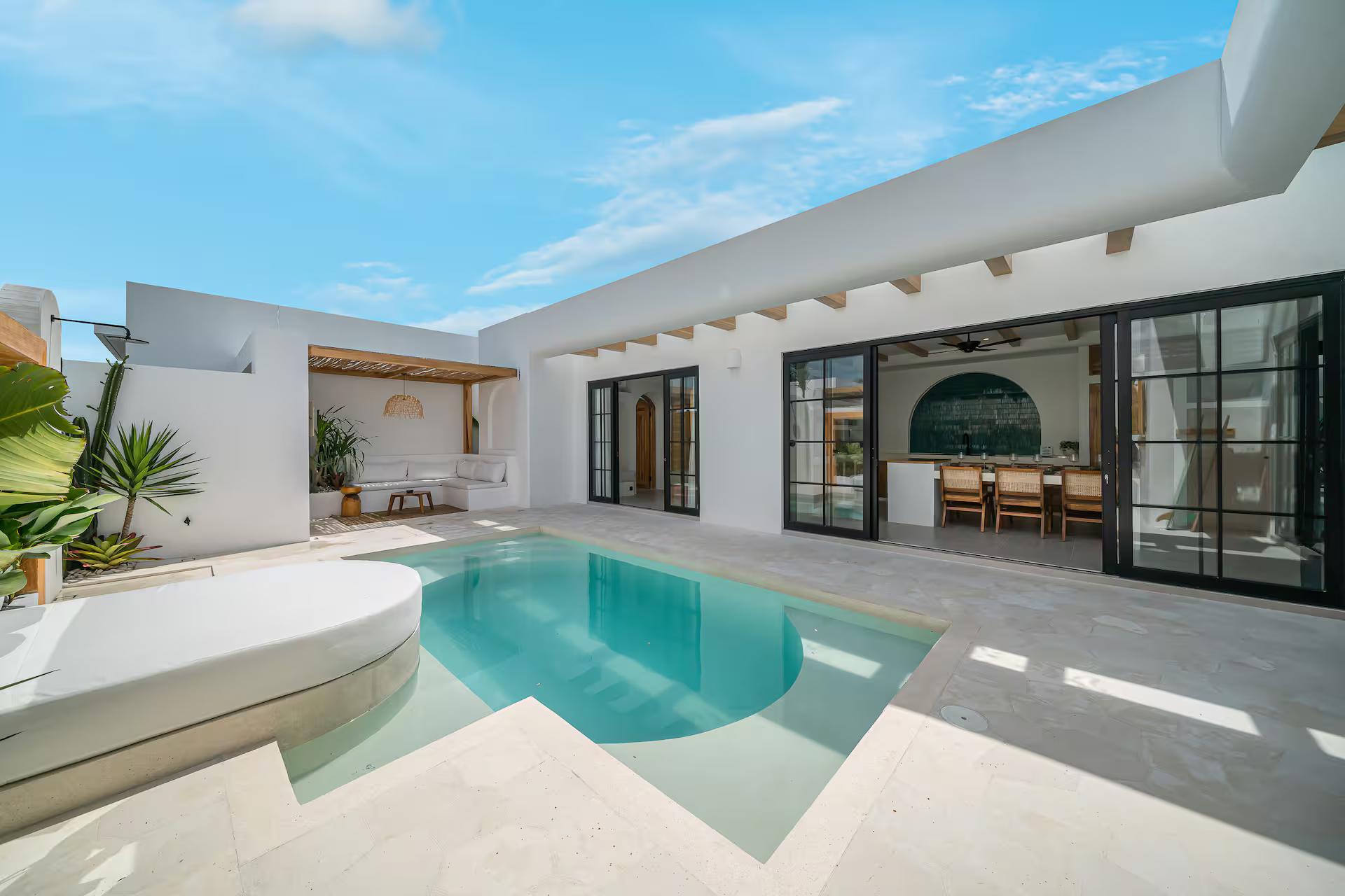The courtyard pool at Casa Shams, whitewashed walls and timber beams wrapping three sides