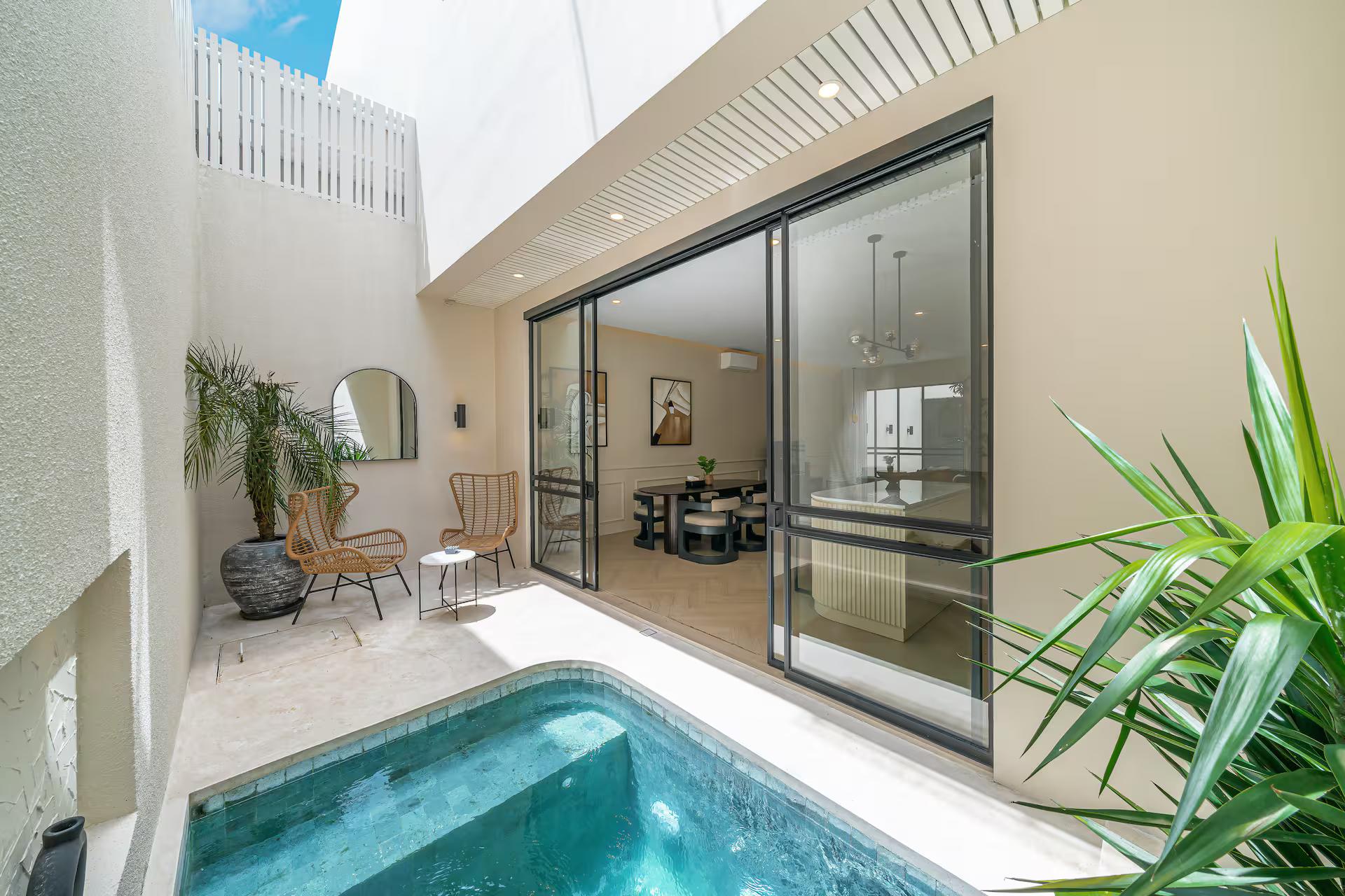 The plunge pool at Chandler Berawa in its walled courtyard, glazed on two sides