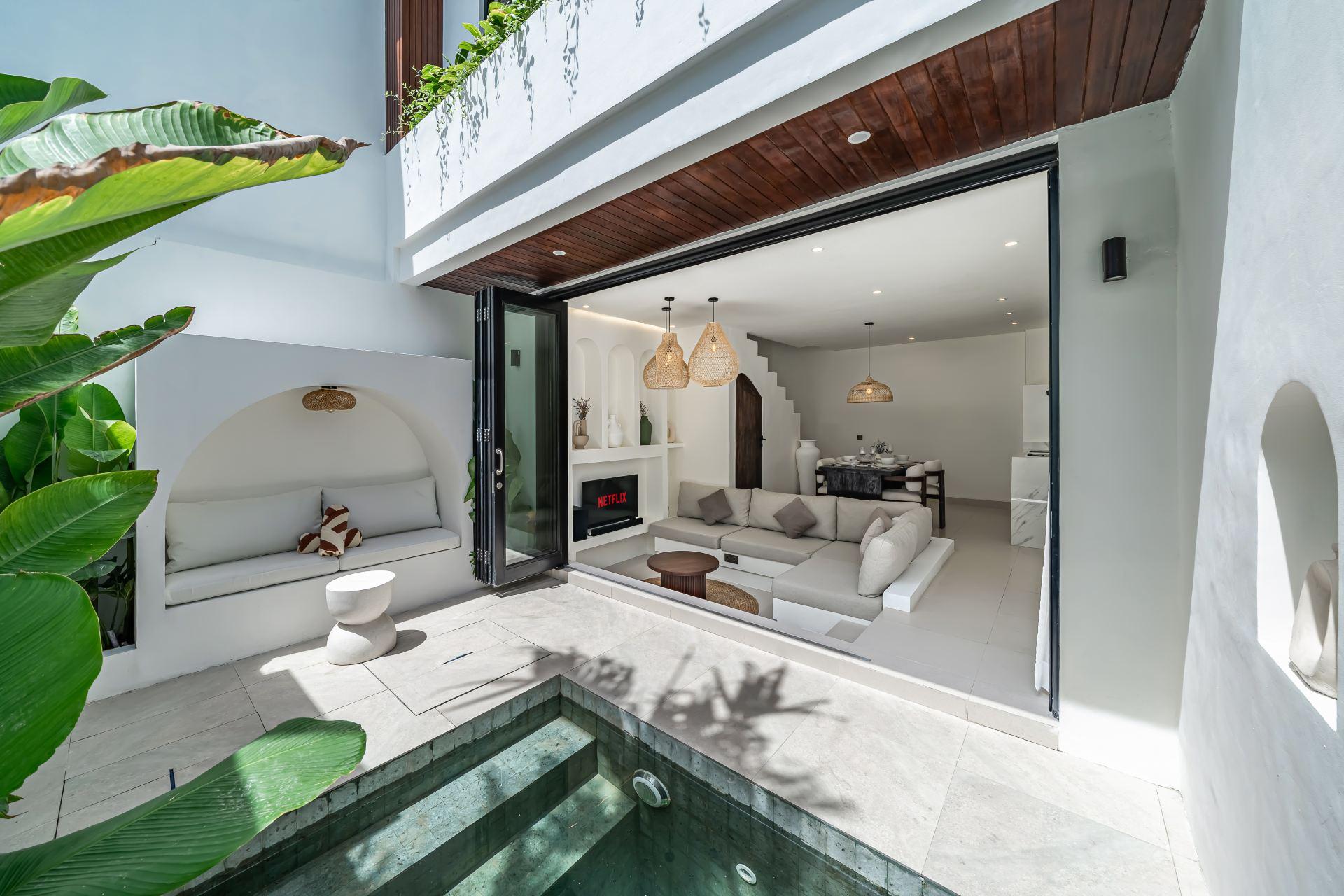 The green-tiled plunge pool at Nova Oasis Berawa 5, with the living room folded open beside it