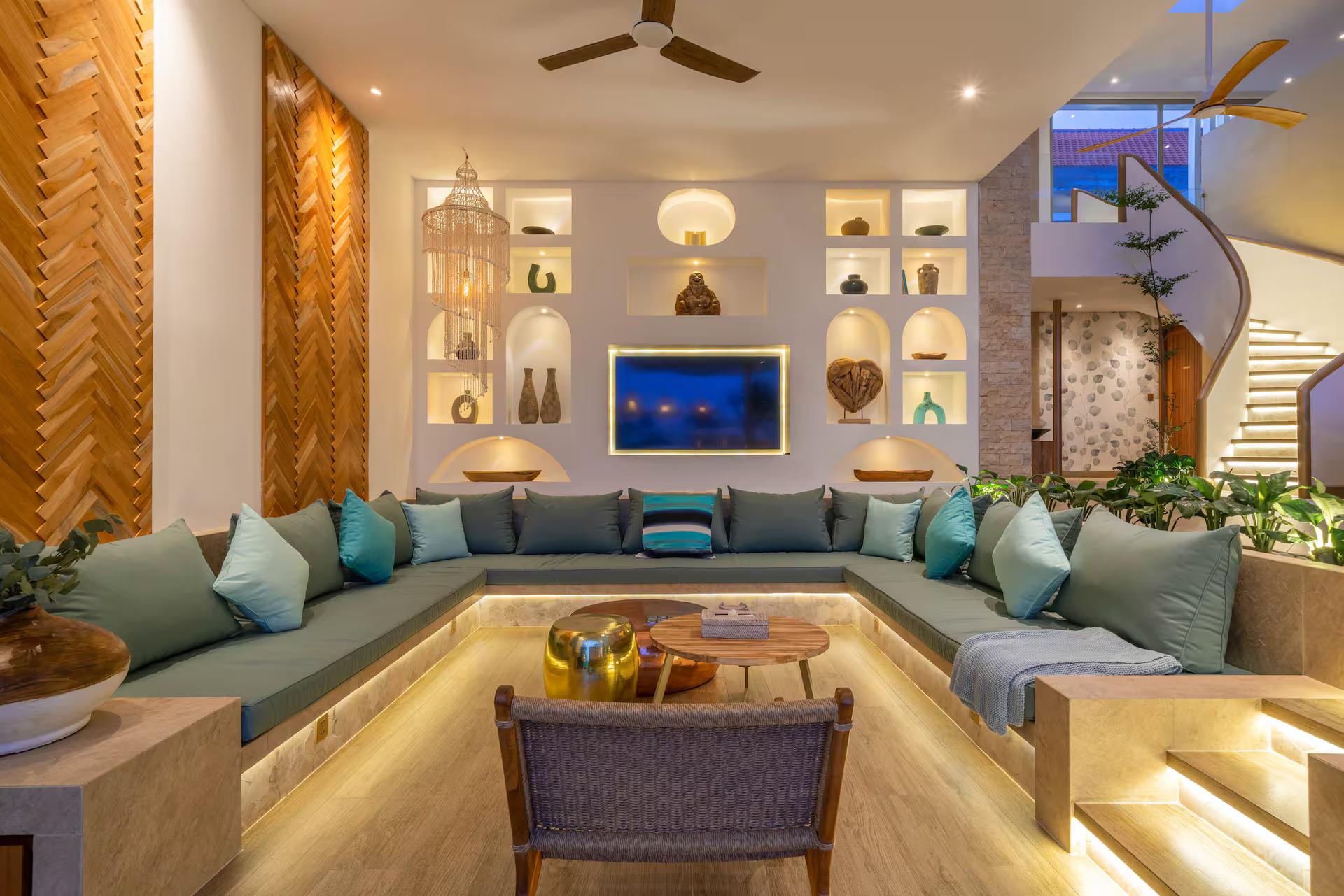 Sunken living room at Villa Vida & Vola, turquoise cushions below a wall of niches