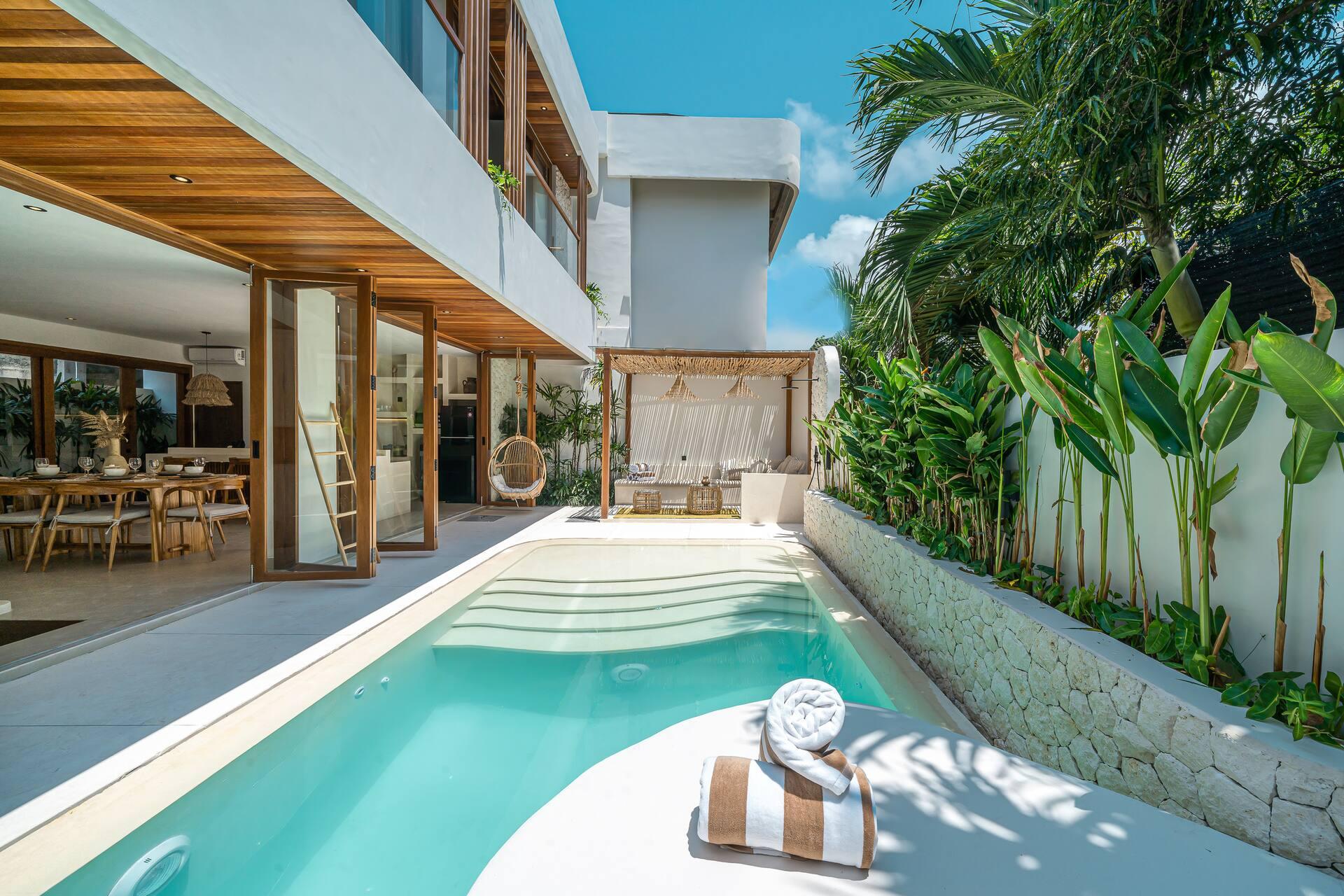 Folding timber doors open the whole ground floor of Villa Paraiso onto the pool terrace