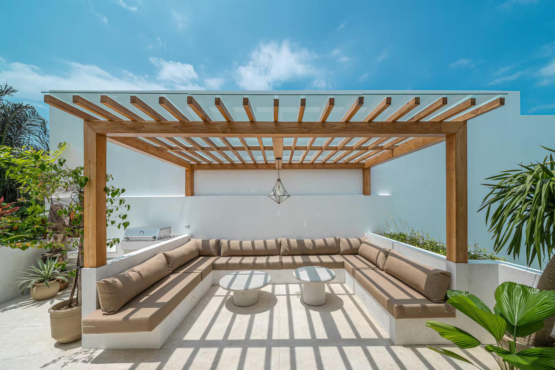 Slatted timber pergola shading a long built-in banquette on the upper terrace at Casa Amici 8