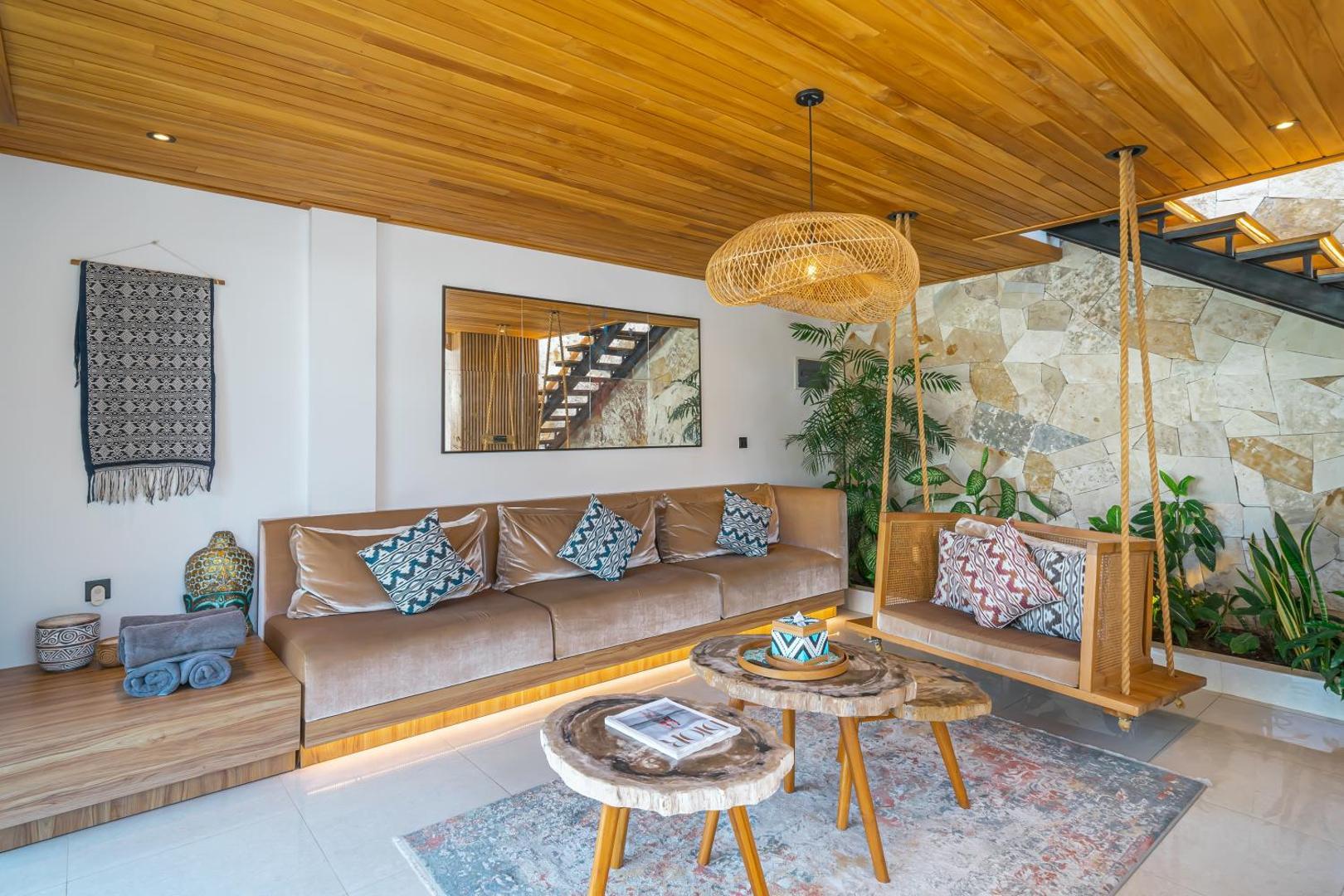 Built-in leather banquette and ikat cushions below the honey limestone living-room wall