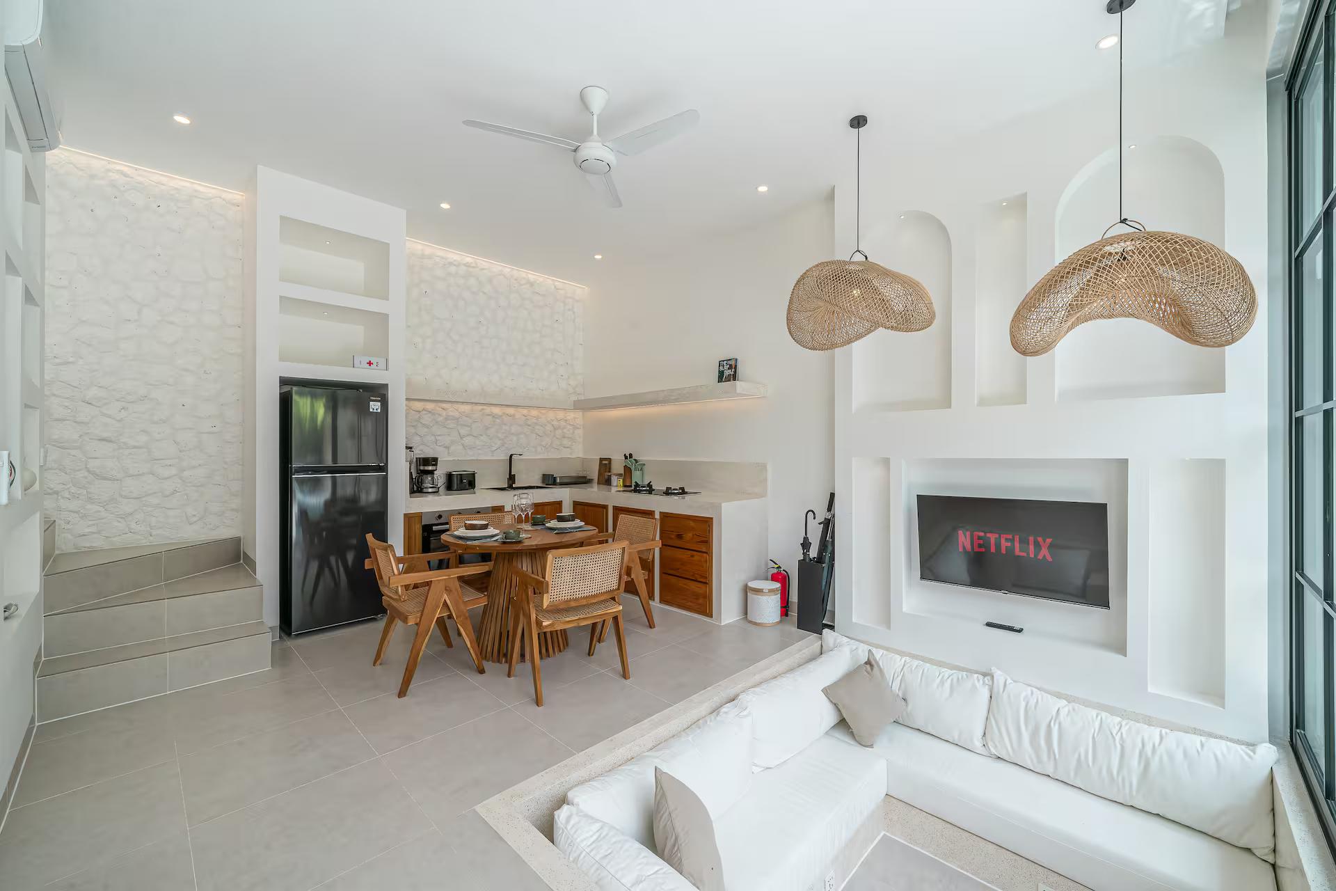 Sunken plaster lounge at Mareo looking through to the timber dining table and kitchen