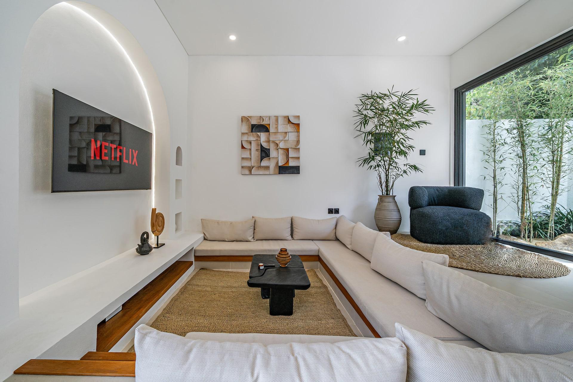 Sunken lounge at Villa Nara, a cream sectional set into a timber well around a jute rug