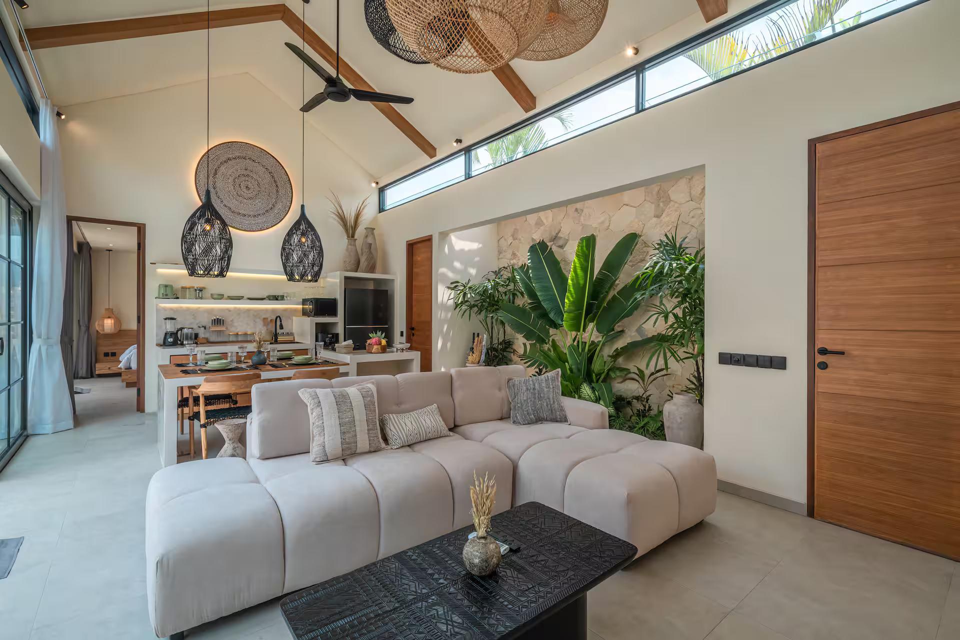 Living room under a high pitched ceiling, linen sofas facing the arched television niche