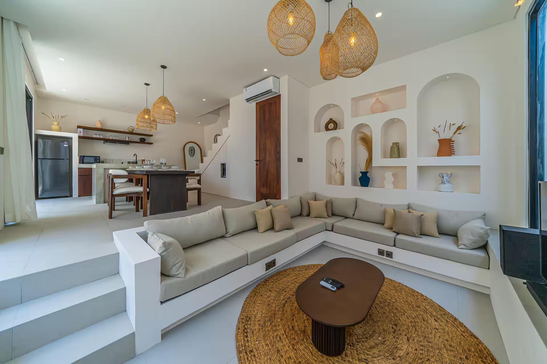 Built-in sunken sofa at Nova Oasis 4 below a wall of arched plaster display niches