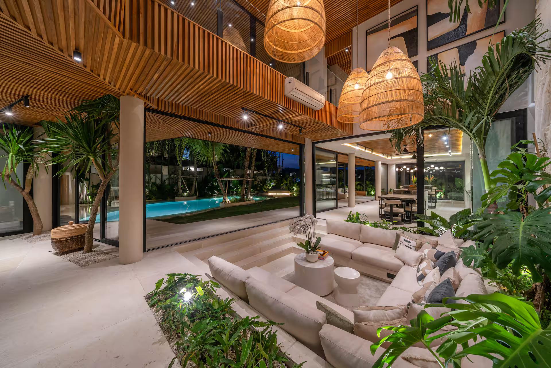 Open living room at Villa Coco Bay, sectional set into a stepped platform among planting