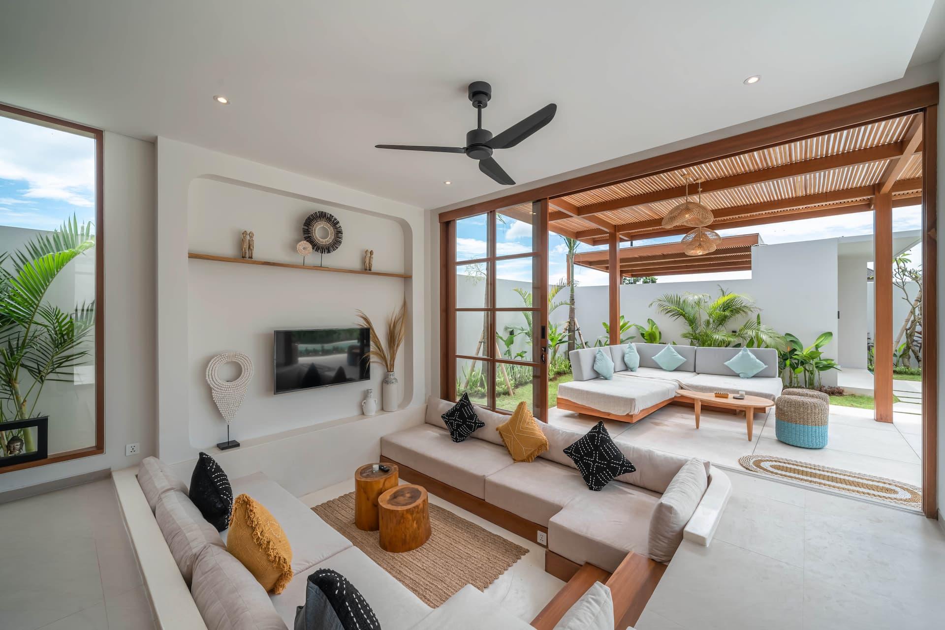 Open-plan living room at Villa LouLou looking straight out through folding doors to the pool terrace