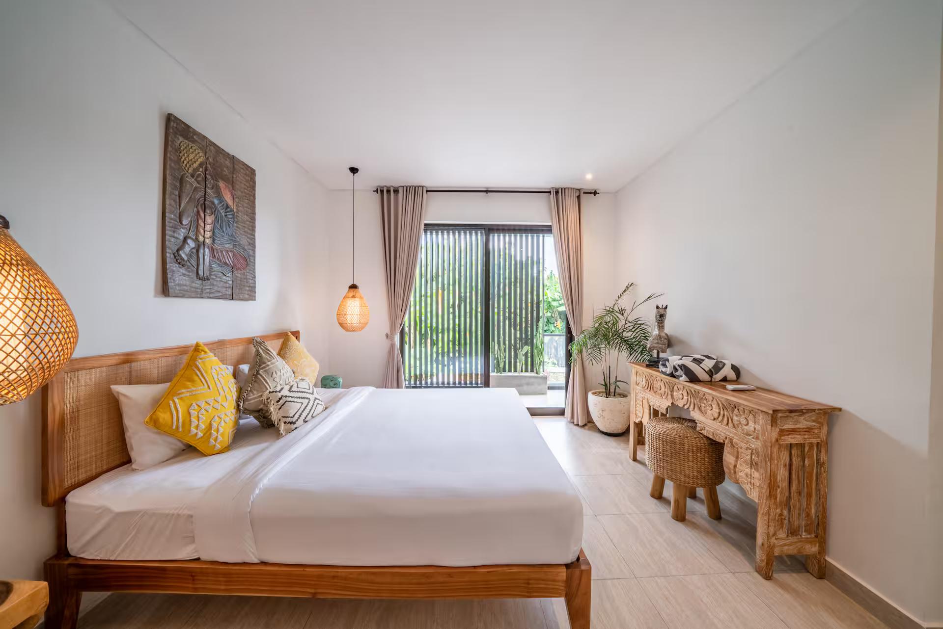 King bedroom with a timber bed frame, rattan pendant and a live-edge console