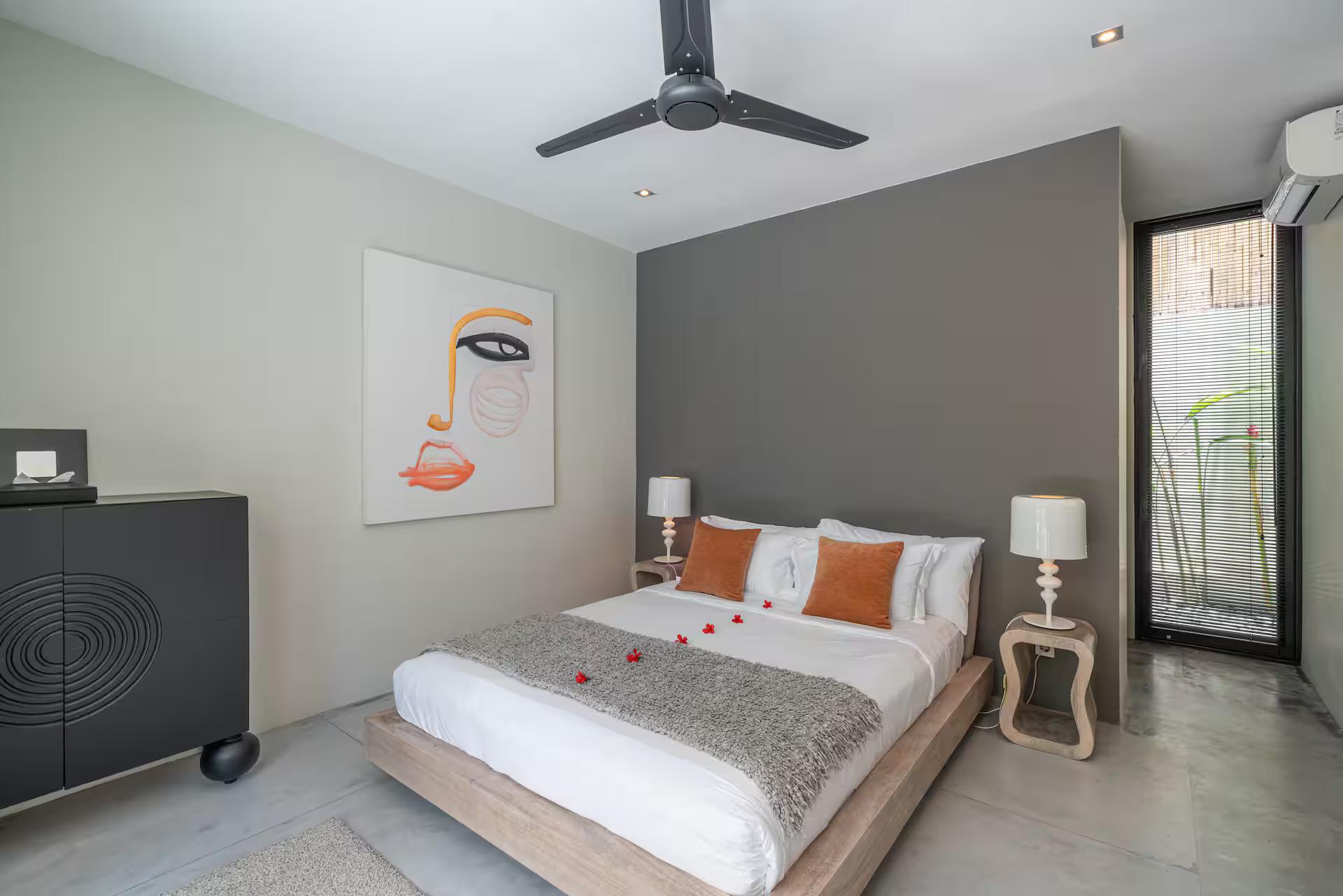 Bedroom with a line-drawing canvas, charcoal cabinet and polished concrete floor