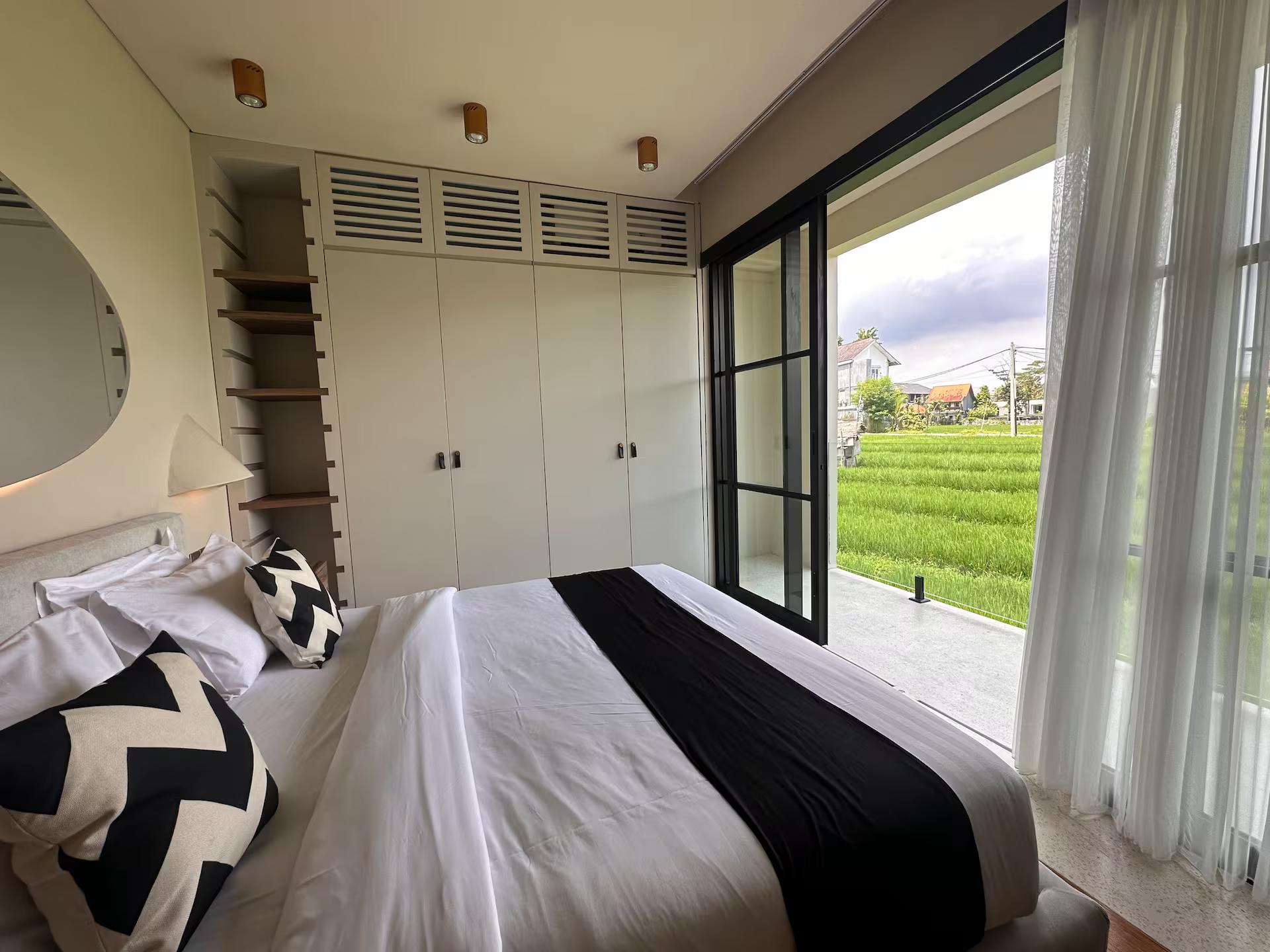 Bedroom at Villa Vesna 7 with sliding glass opening straight onto the green rice fields