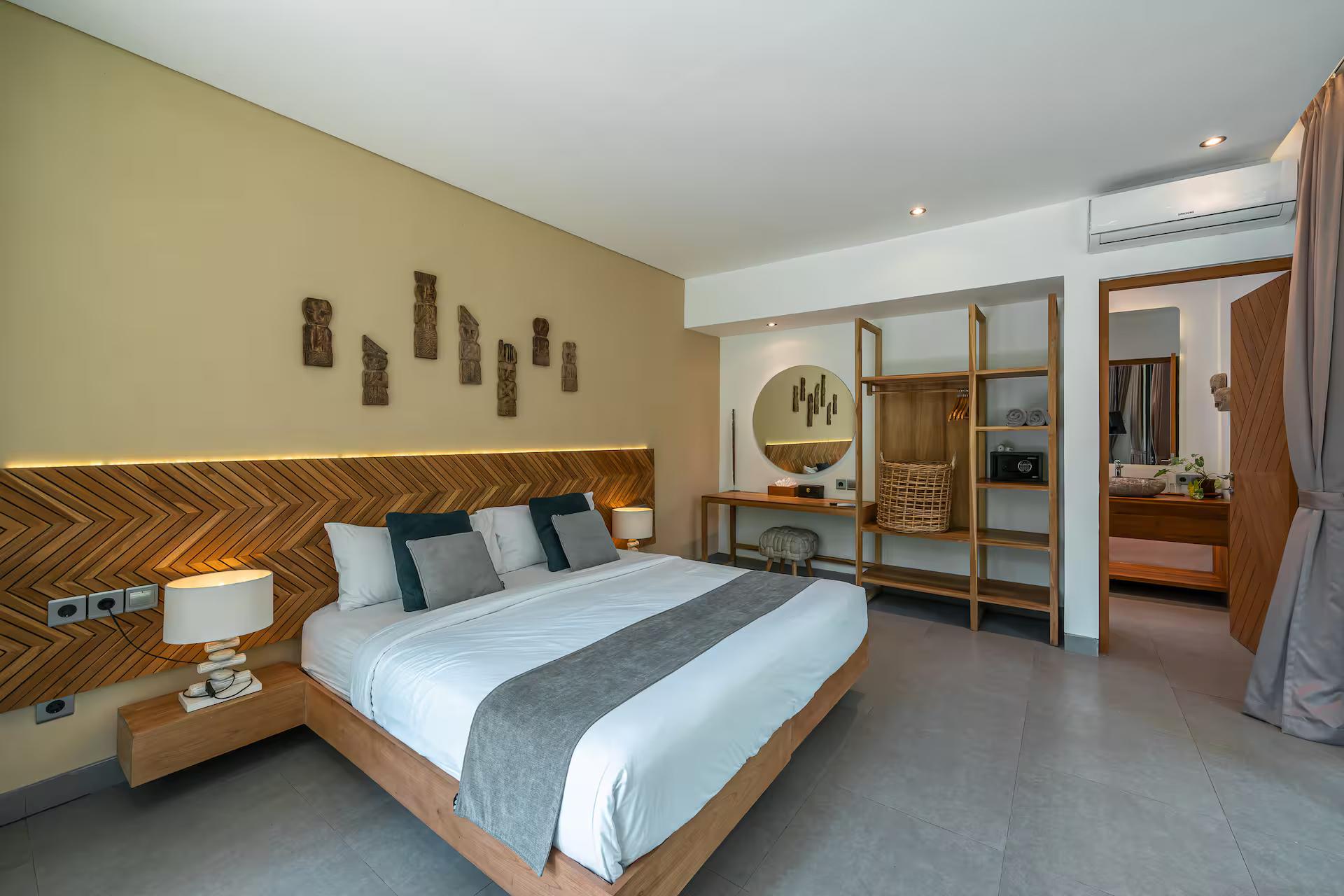 Bedroom with a chevron timber headboard wall and a dressing area behind the bed