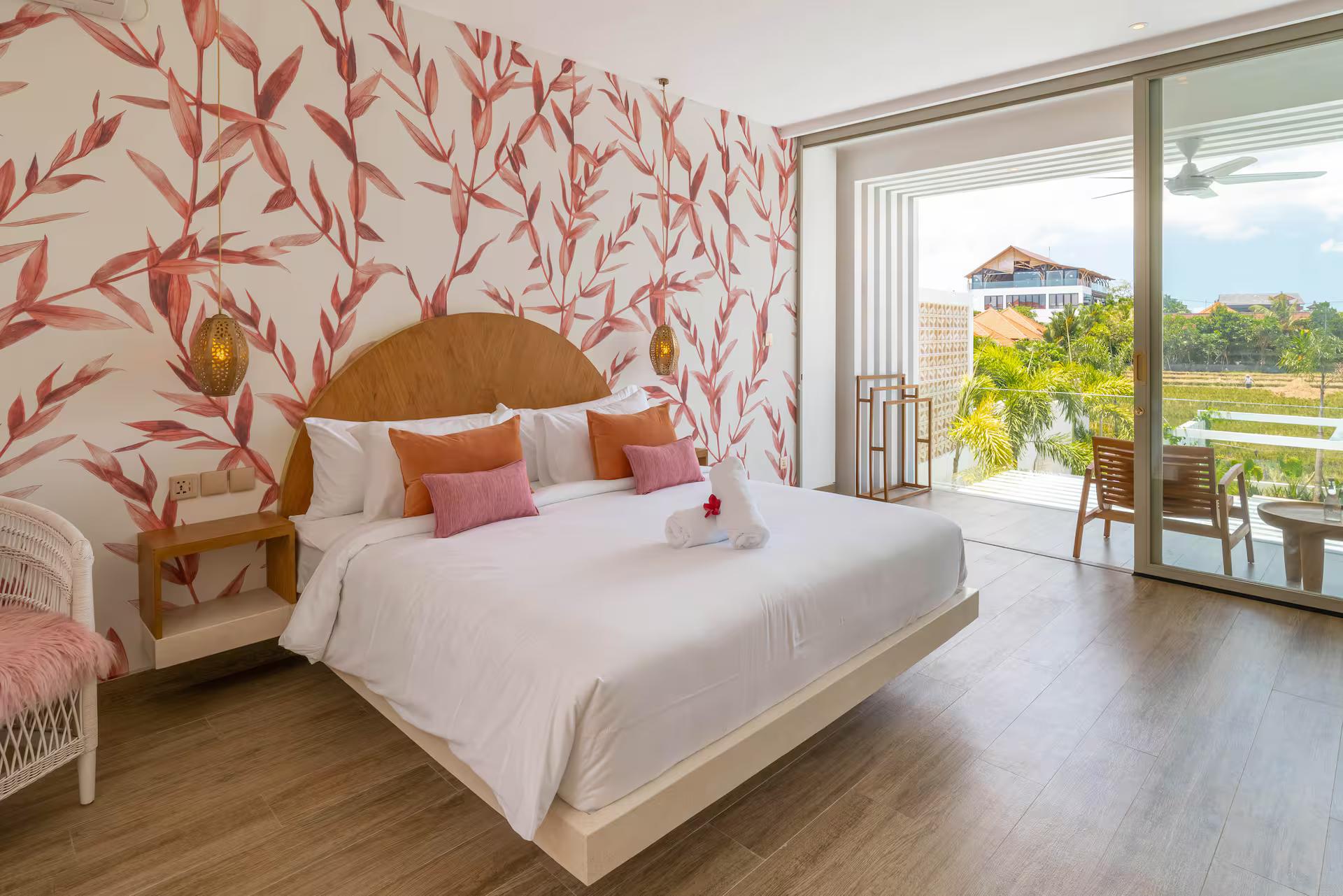Bedroom with a red-leaf mural, arched timber bedhead and doors onto the terrace