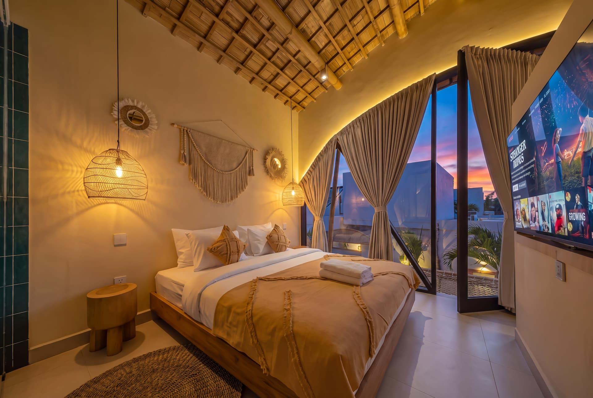 Upstairs master bedroom at Villa Tigana beneath its woven bamboo vaulted ceiling