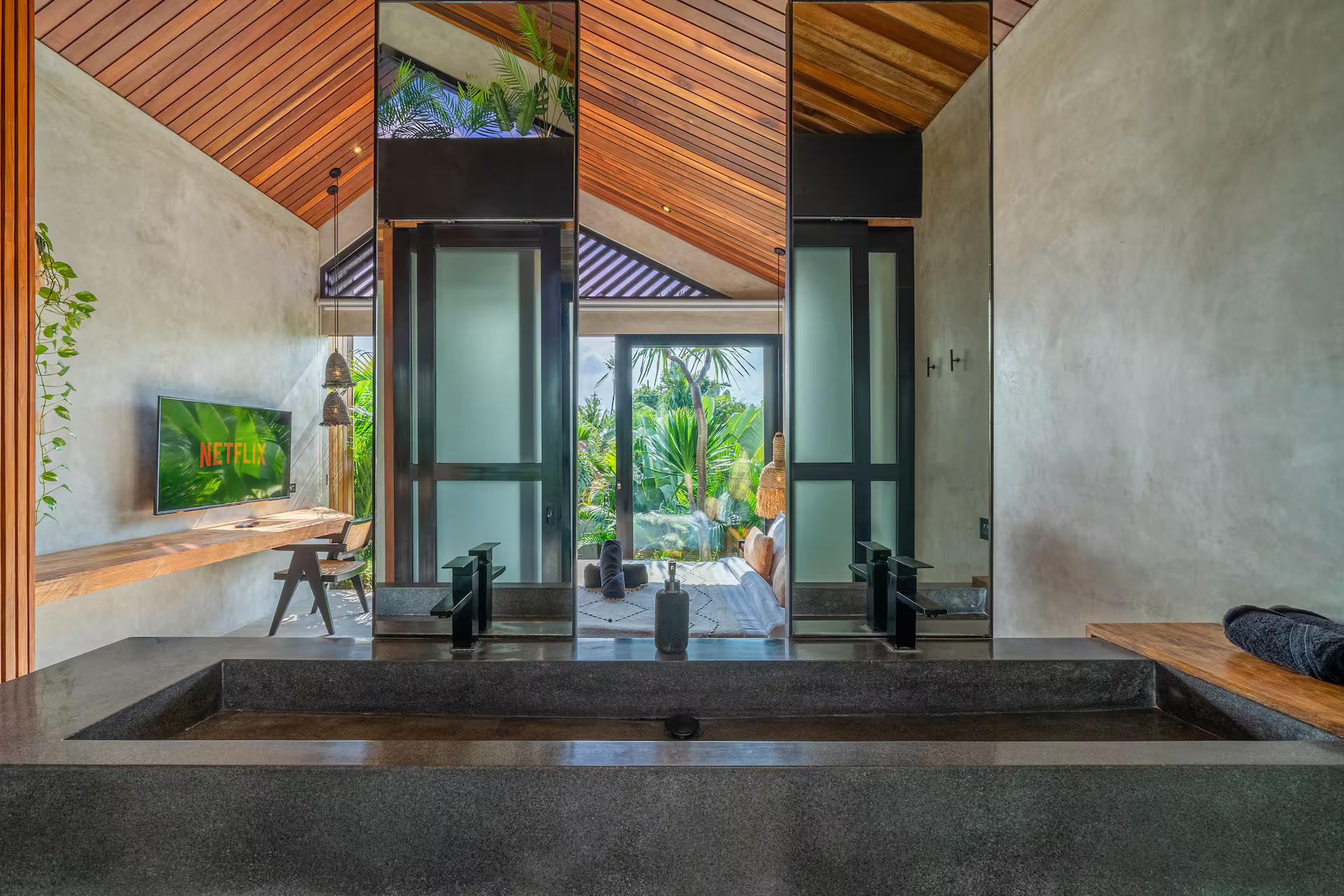 Twin basins carved into one slab of dark cast stone in the upstairs en-suite at Villa Solani