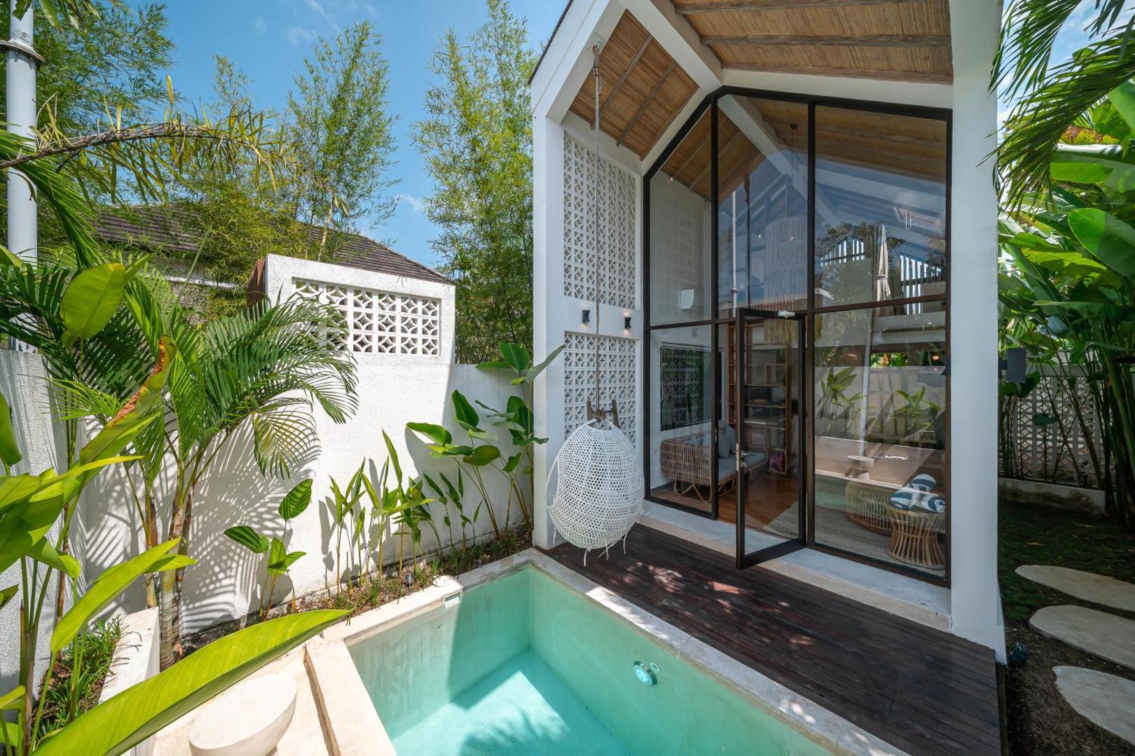 The A-frame gable of Villa Tiny 2 glazed from ridge to deck above the plunge pool