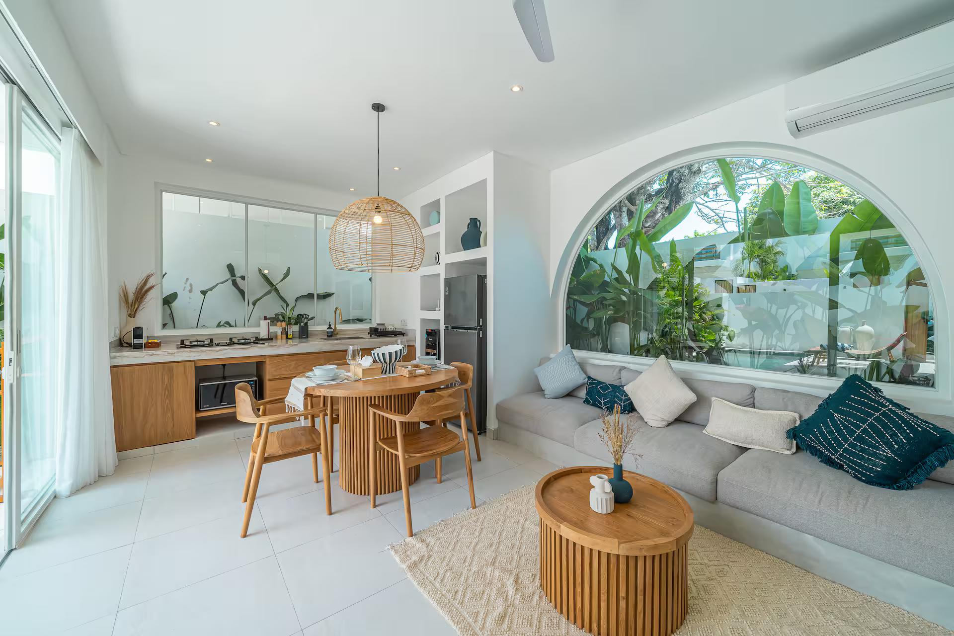 Kitchen, dining and living in one room at Villa Solaia, the arched window beyond