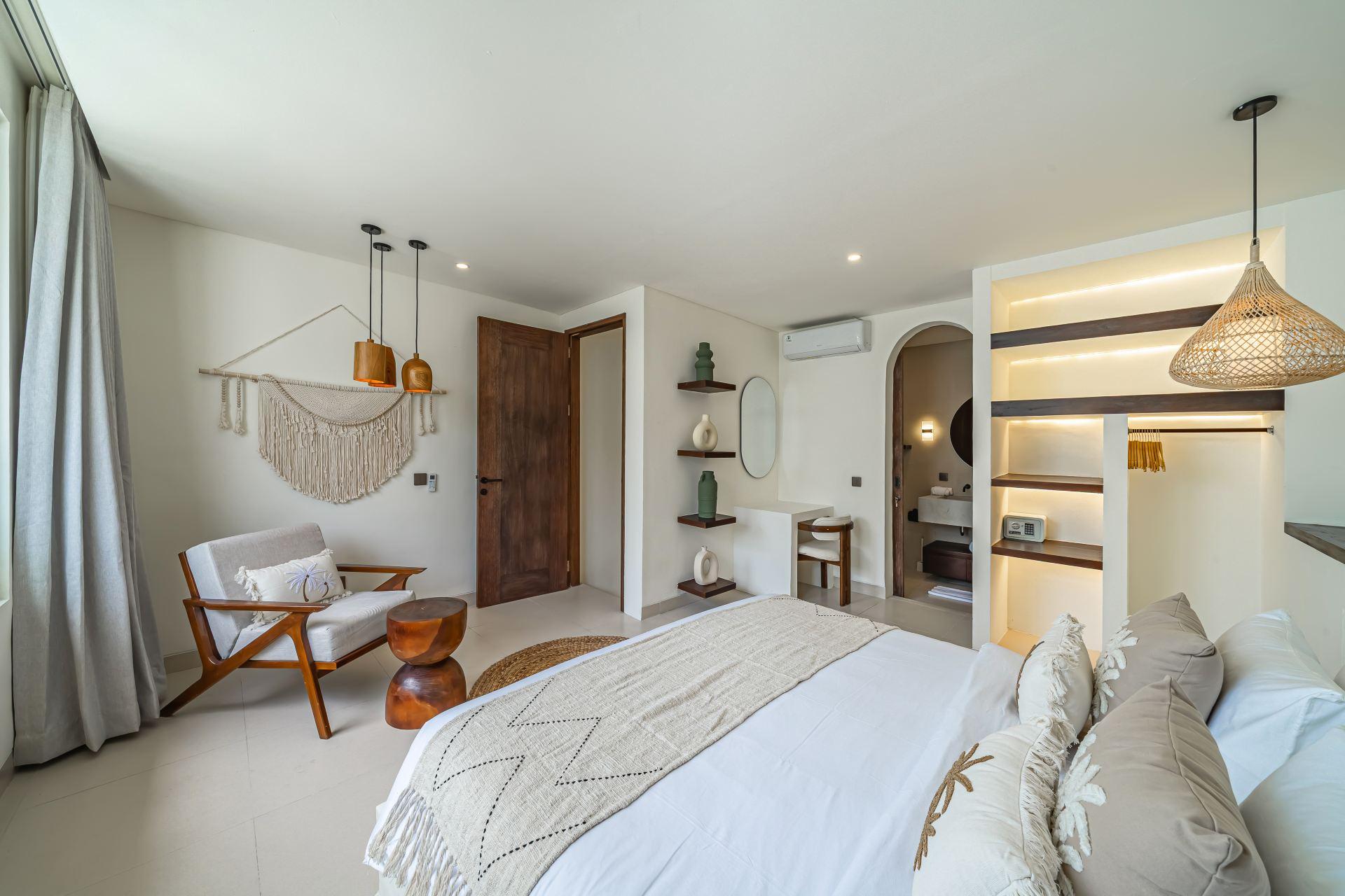 Bedroom wardrobe alcove and desk at Nova Oasis Berawa 5, with the en-suite through the arch