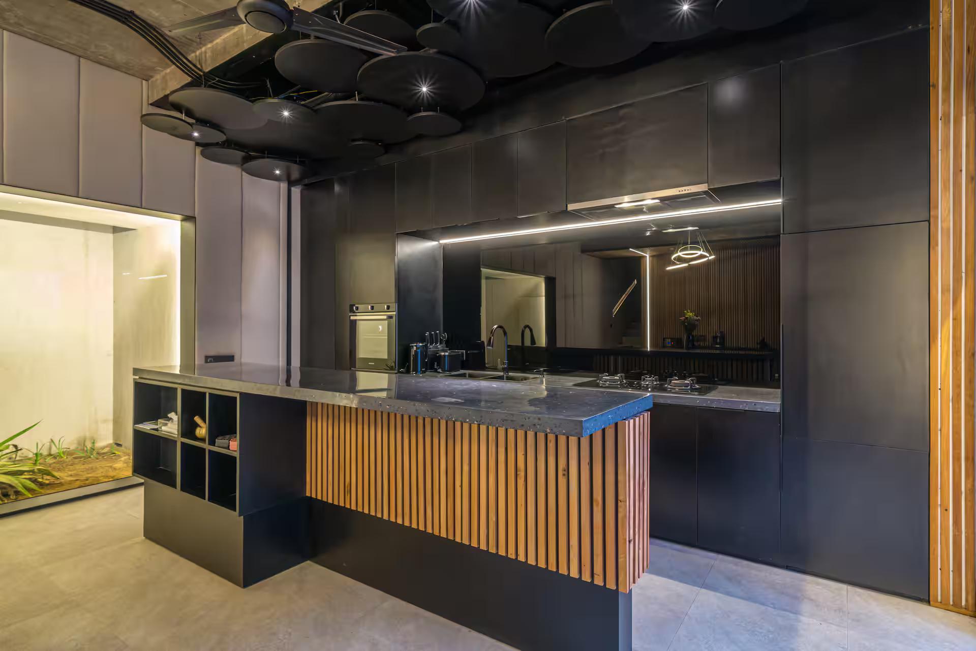 Matte black kitchen at Villa Sunset Berawa with a fluted timber island front