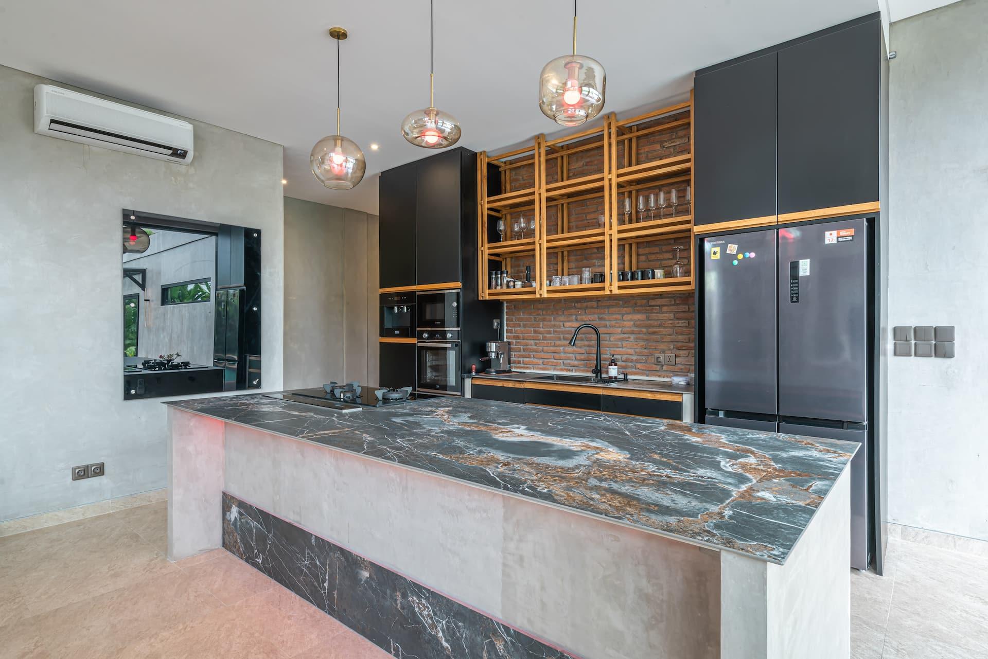Kitchen with a marble-topped island, black cabinetry, timber open shelving and glass pendants