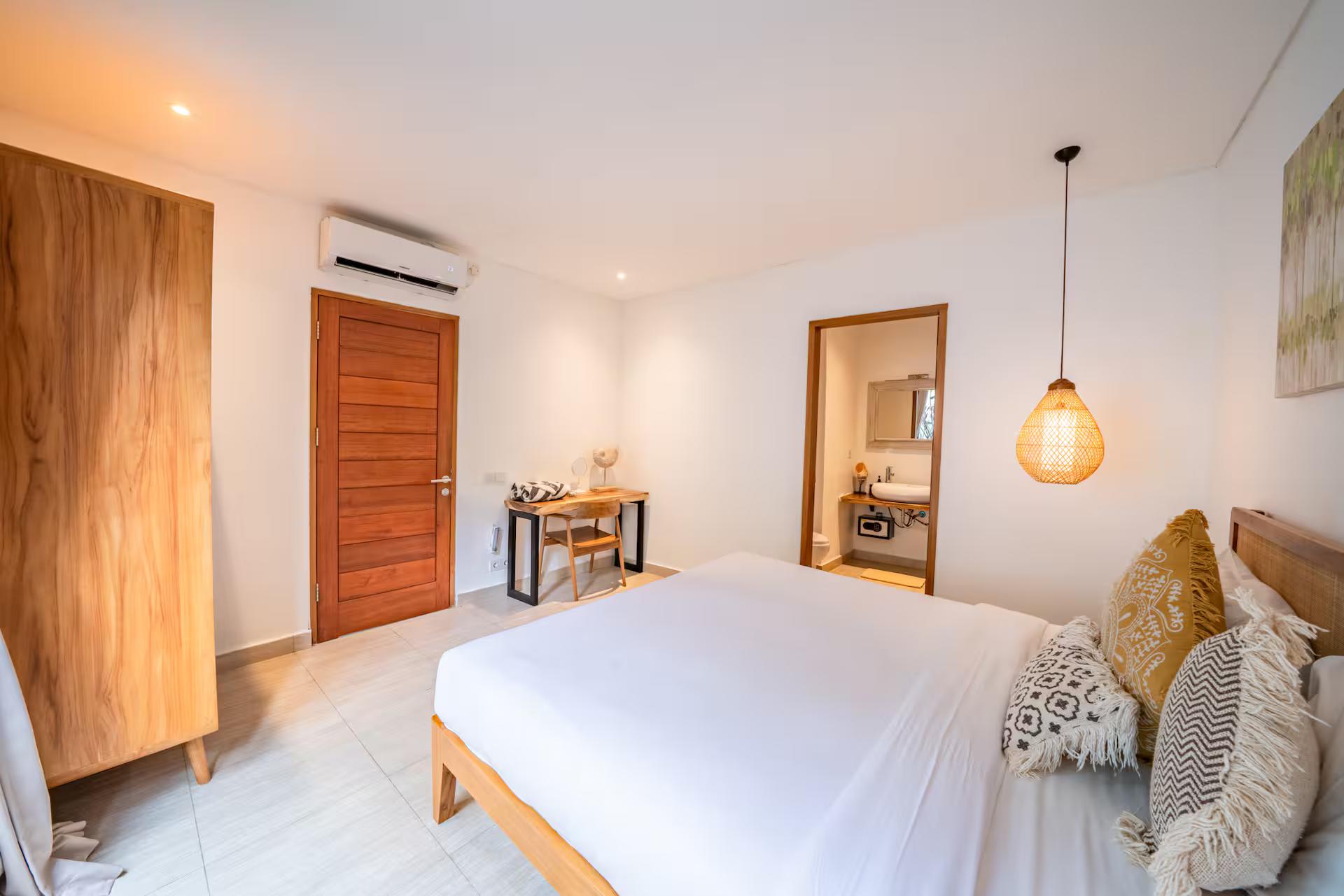 Second king bedroom with a tall timber wardrobe and a dressing nook with a mirror