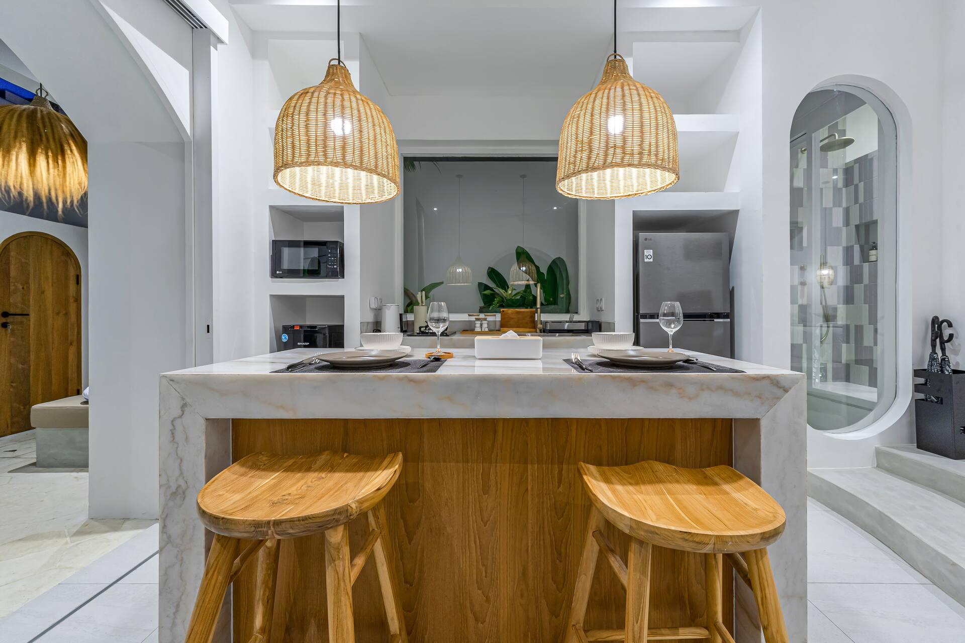 Marble island with turned timber stools, arched display niches cut into the plaster
