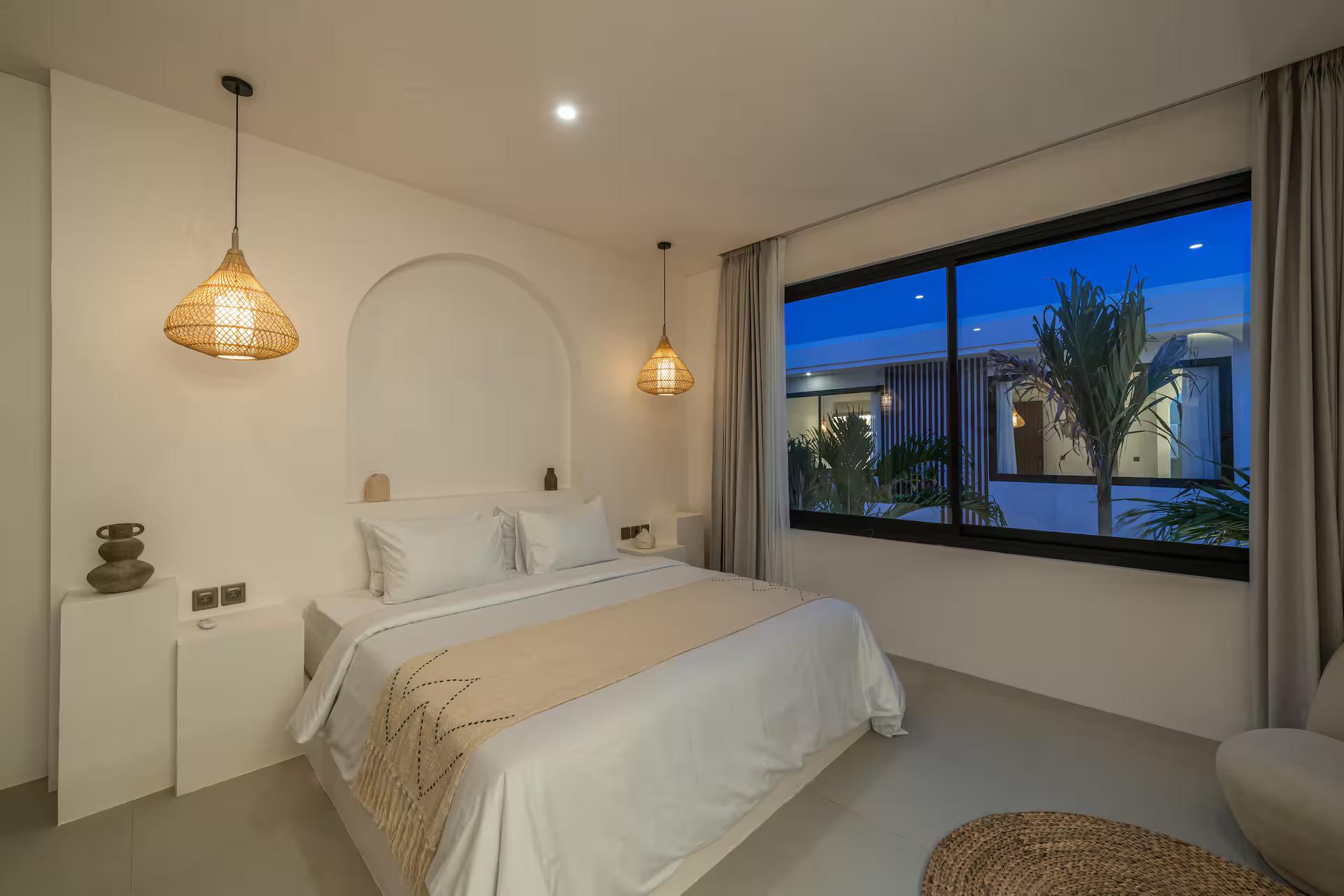 Second bedroom at Nova Oasis 4, the bed set inside a tall arched plaster recess