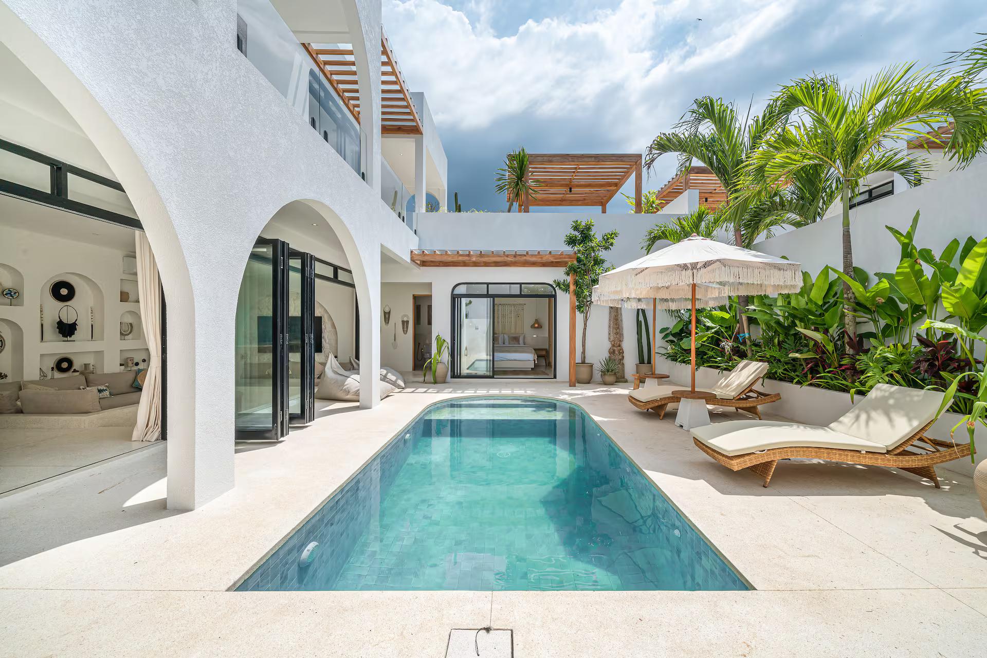 The courtyard pool at Bellavista Amici, curved at one end and lined in green-teal mosaic