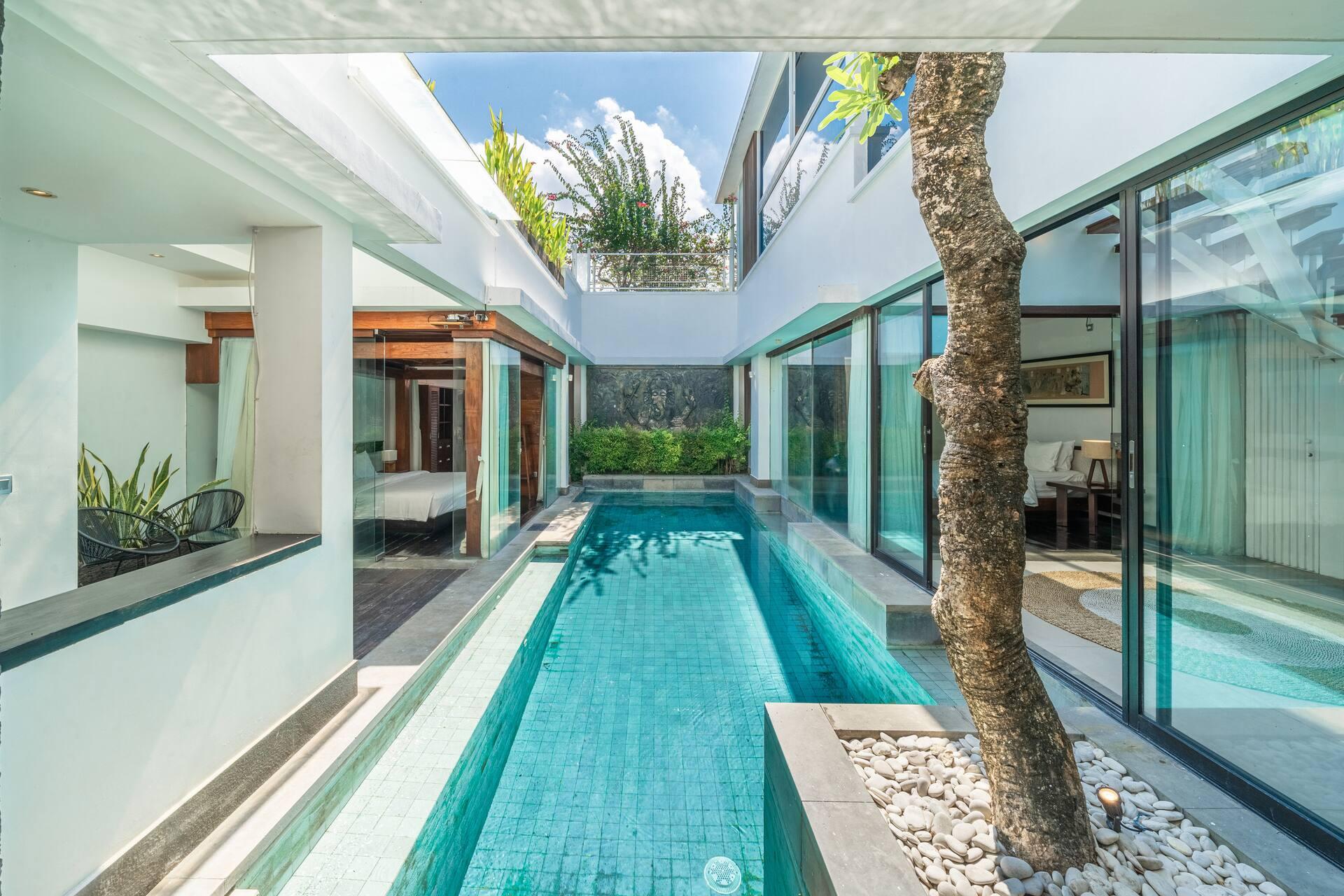 The lap pool running the full length of Villa Tykhe between its two ground-floor wings