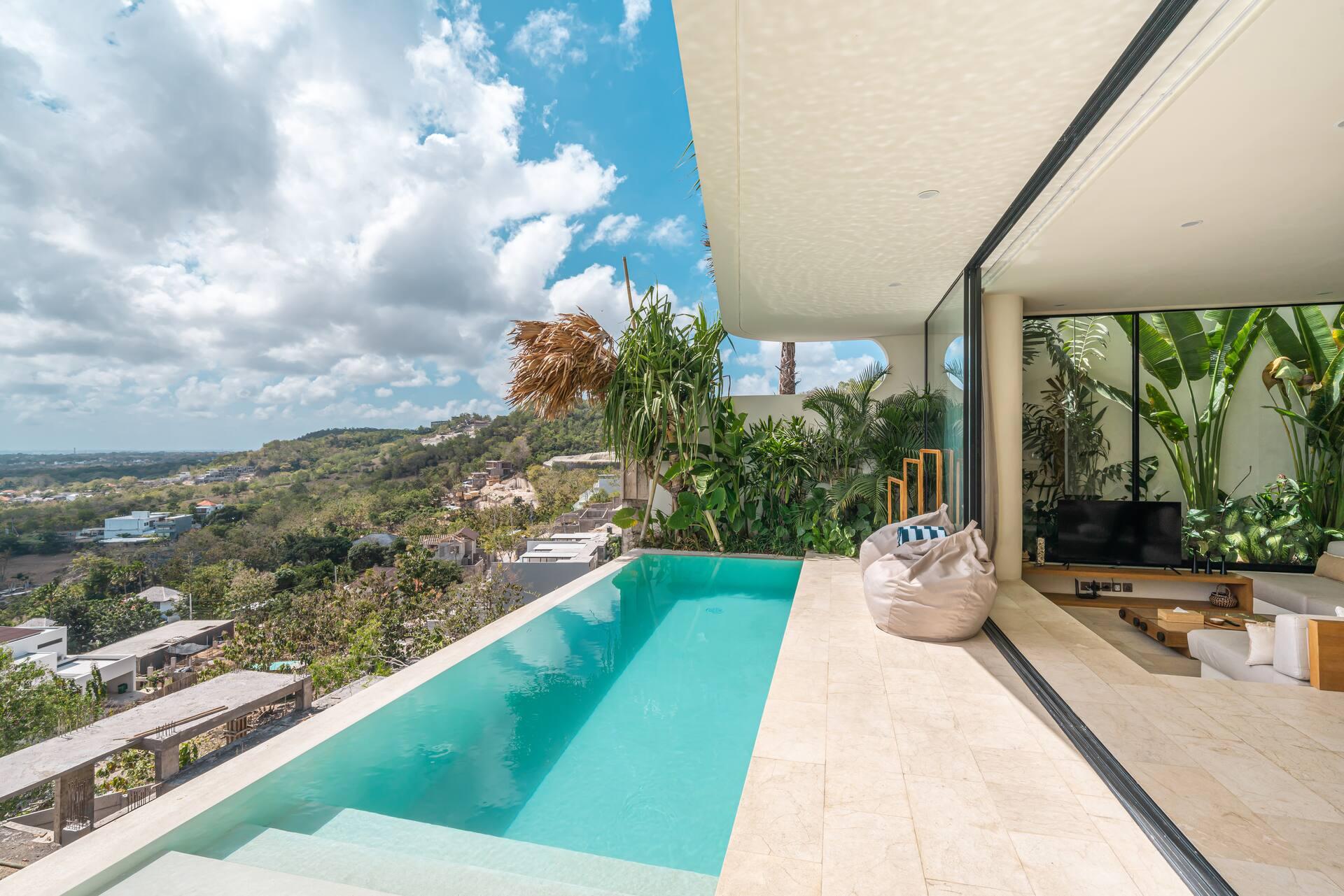 Villa Amanecer's turquoise pool on the edge of the terrace, with wide views over the Bukit to the sea