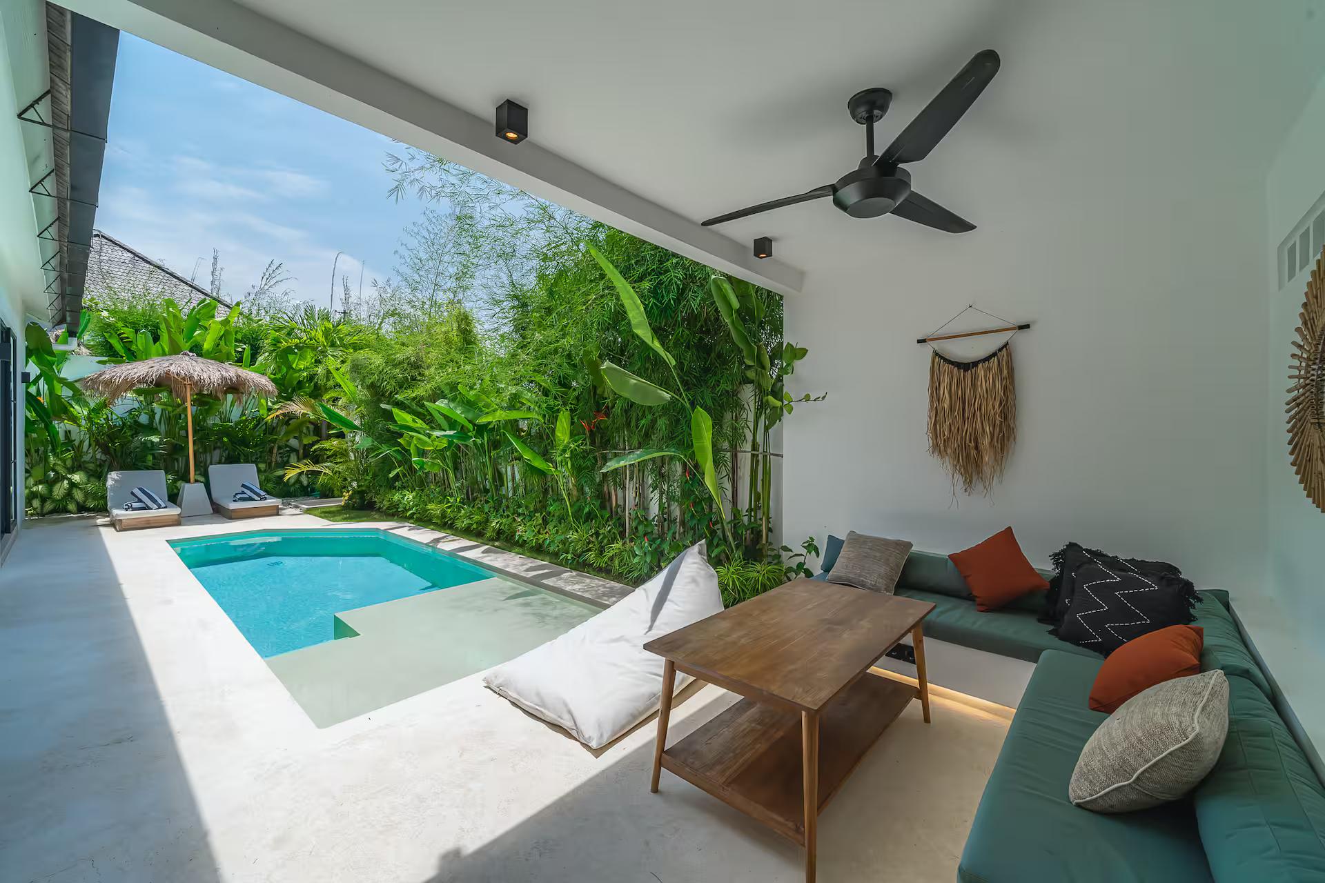 Sunken banquette and low table open to the pool through folding glass doors