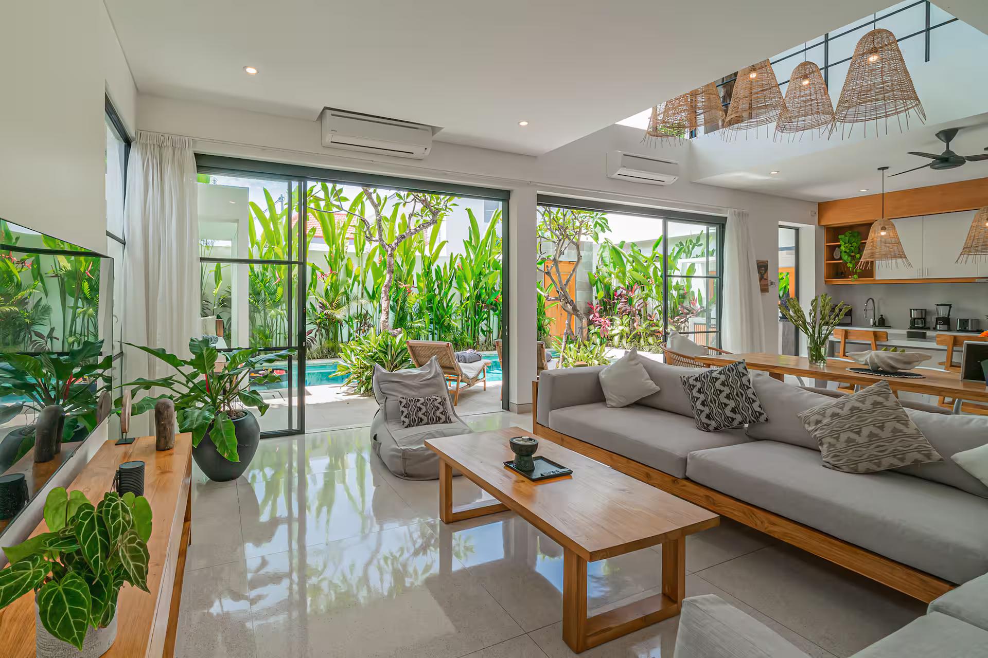 The open-plan lounge at Villa Puri Senang slides straight out to the poolside terrace