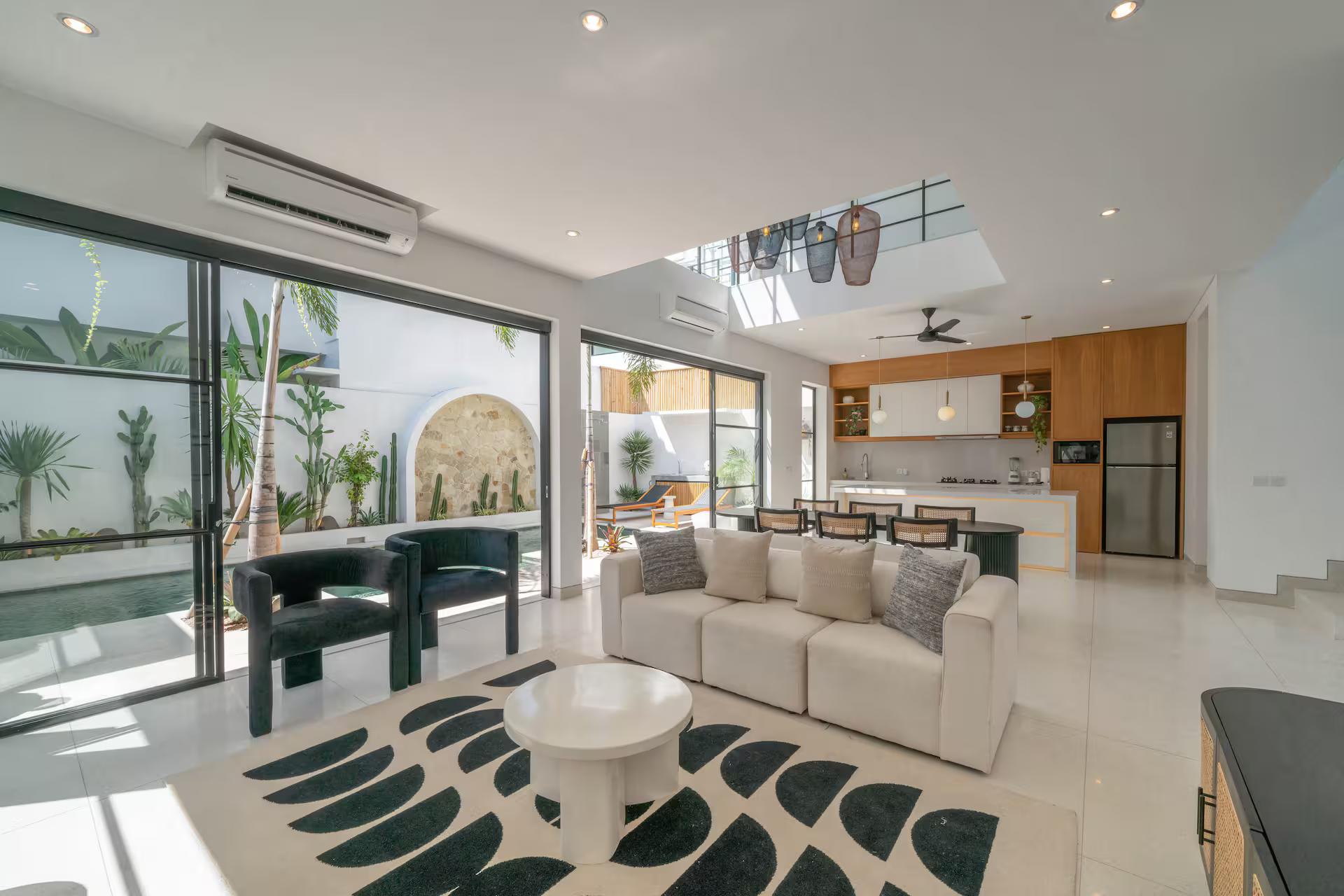 The living room at Casa Embra, cream sofas on a bold black-and-white patterned rug