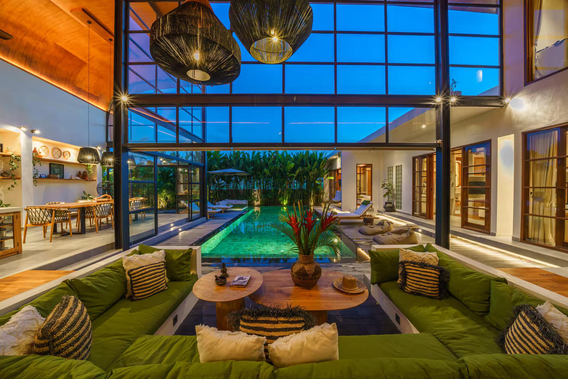 Sunken olive-green lounge set into the floor beside the pool at Villa Mango Bliss