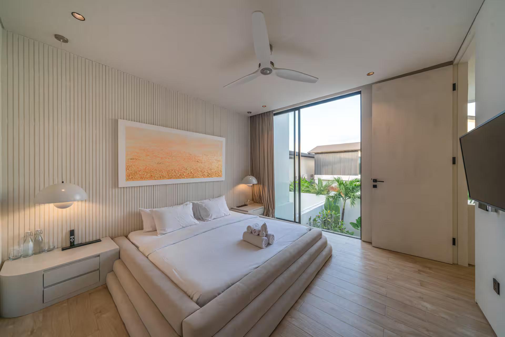 Master bedroom at Villa Kiyoji, reeded wall panelling and a glazed door onto the balcony