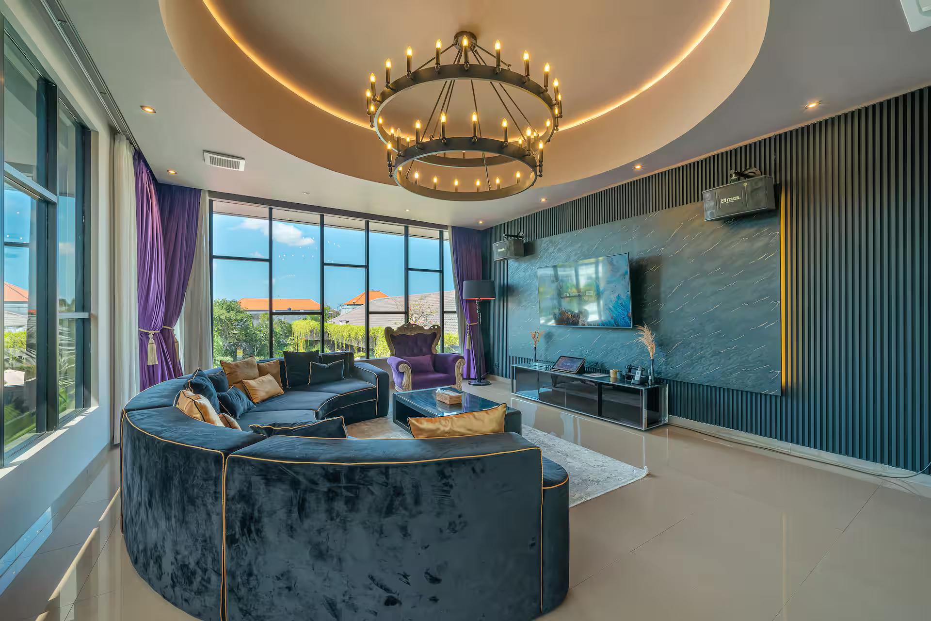 Karaoke room at Villa Nishiki, curved velvet sectional beneath an iron ring chandelier