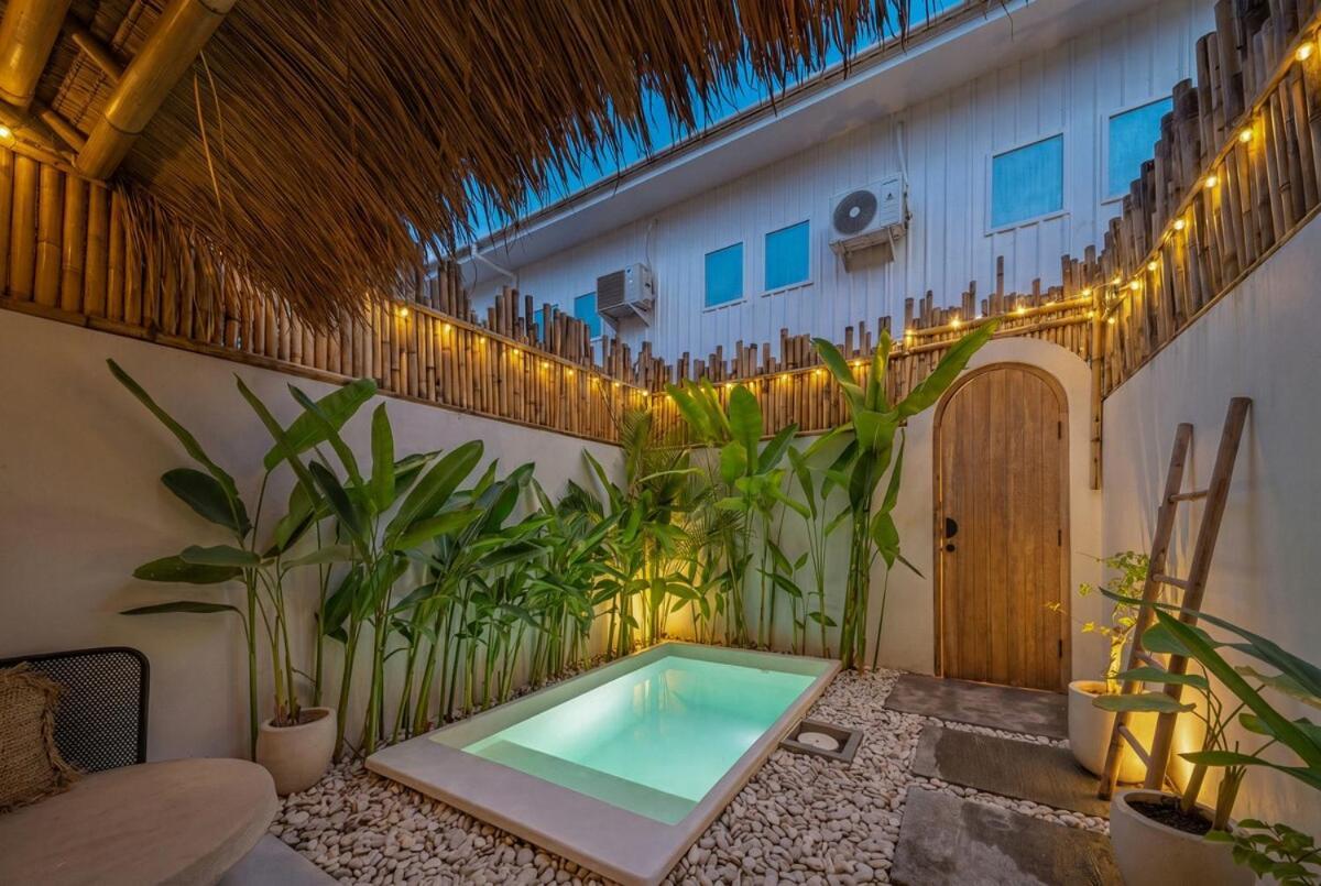 The courtyard at Casadou after dark, warm lights strung beneath the bamboo screen