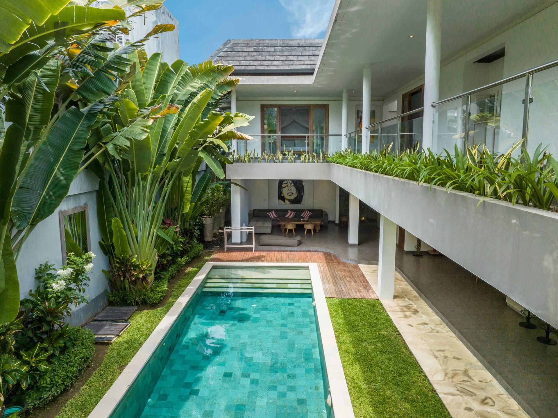 Two-storey garden elevation, the upper gallery planted along its edge above the lap pool
