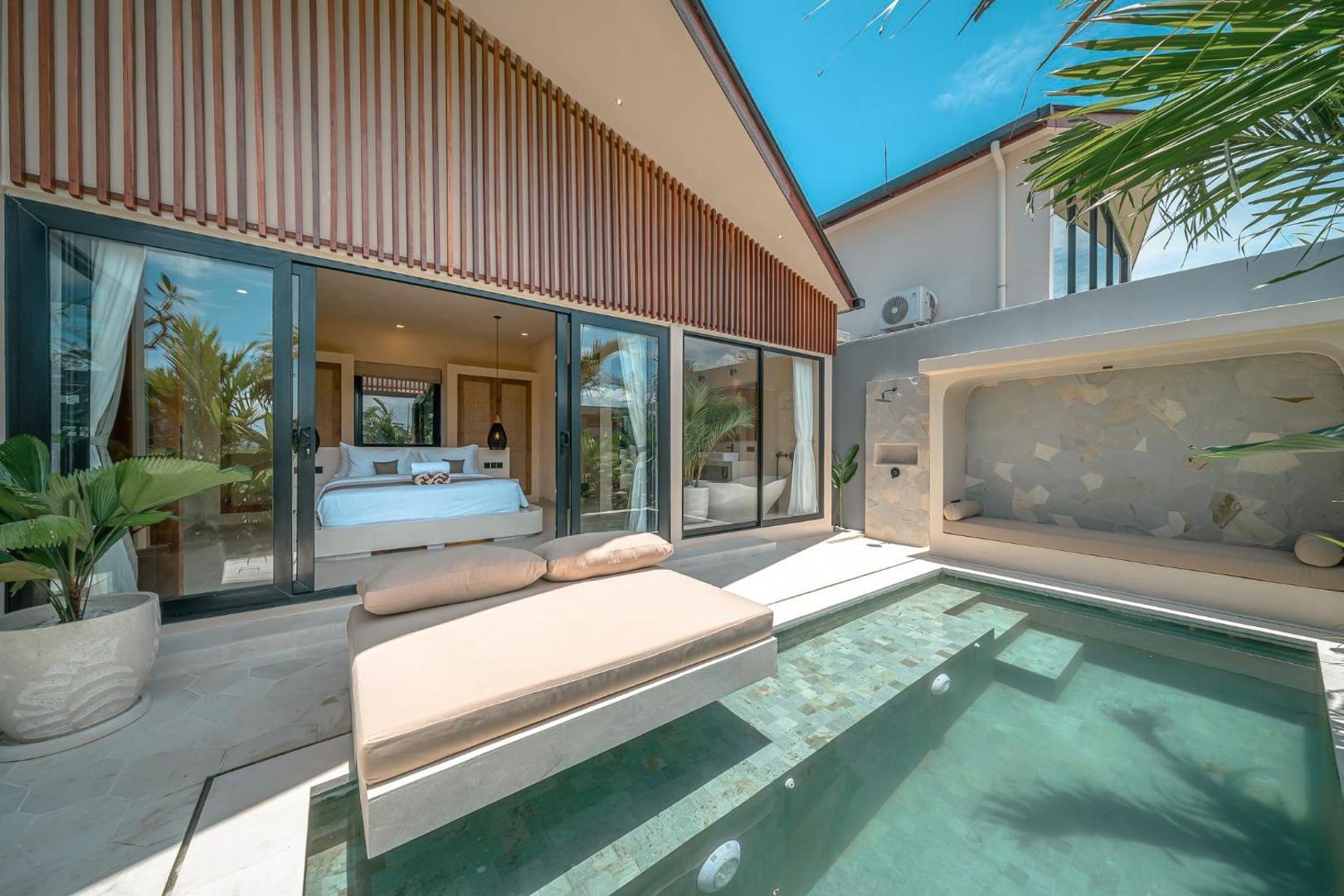The plaster sun platform at the end of the pool at Villa Ayo 1, glass sliding open