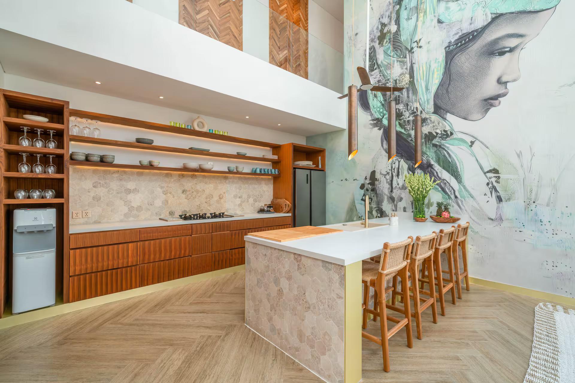 Kitchen island and bar stools beneath a two-storey hand-painted portrait mural