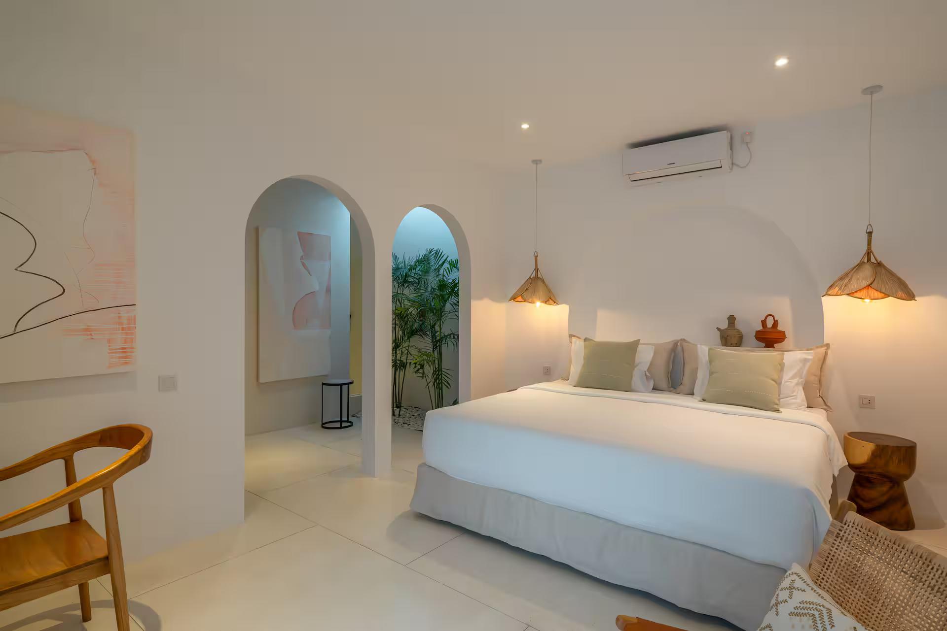 Second king bedroom, its bed set in an arched plaster niche beside twin arched doorways
