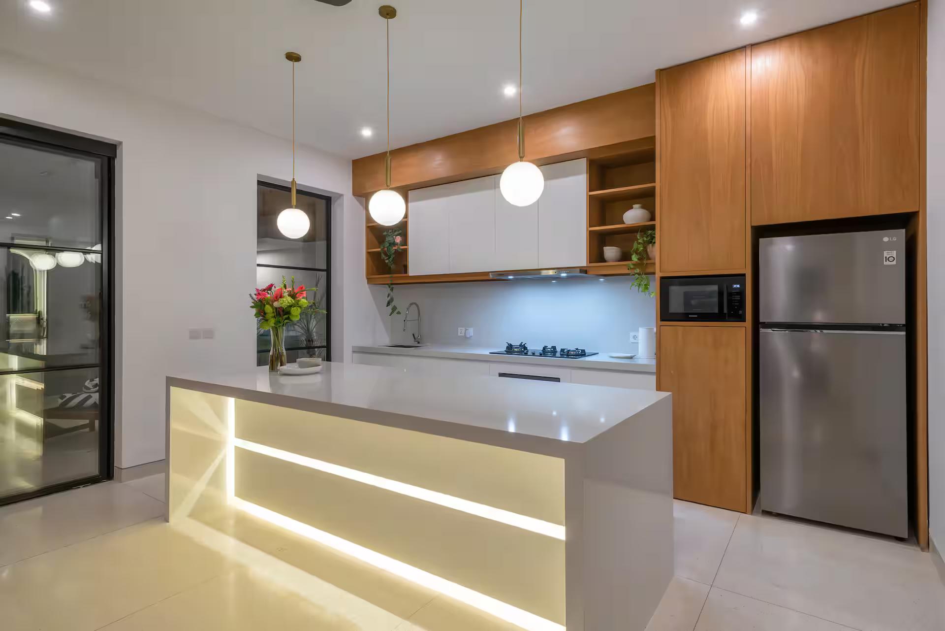 The kitchen island at Casa Embra, lit from within its base under globe pendants