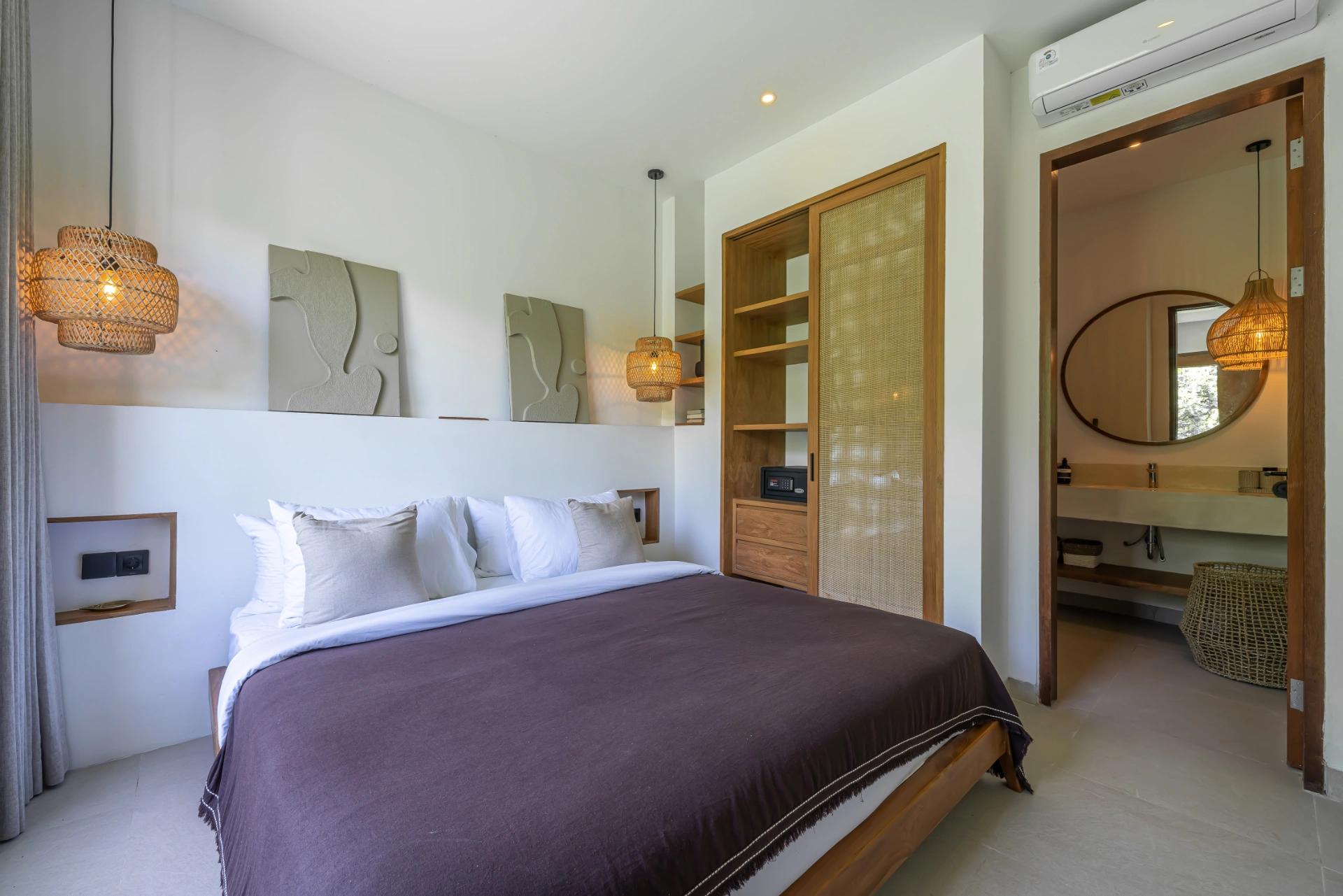 Bedroom with sculpted relief panels on a plaster ledge and a cane-panelled wardrobe