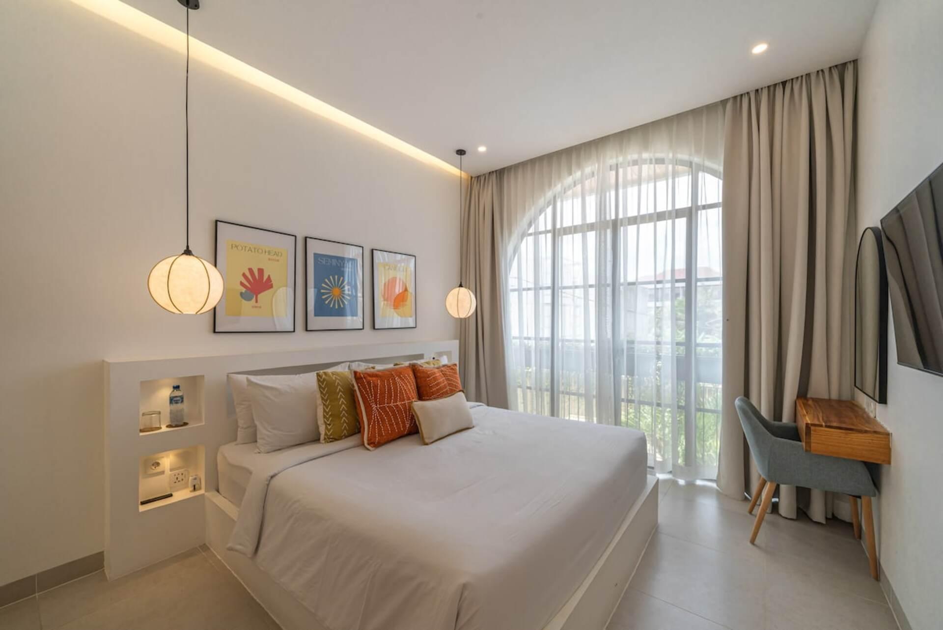 Second bedroom at Villa Polanco, tall arched window and a timber writing desk