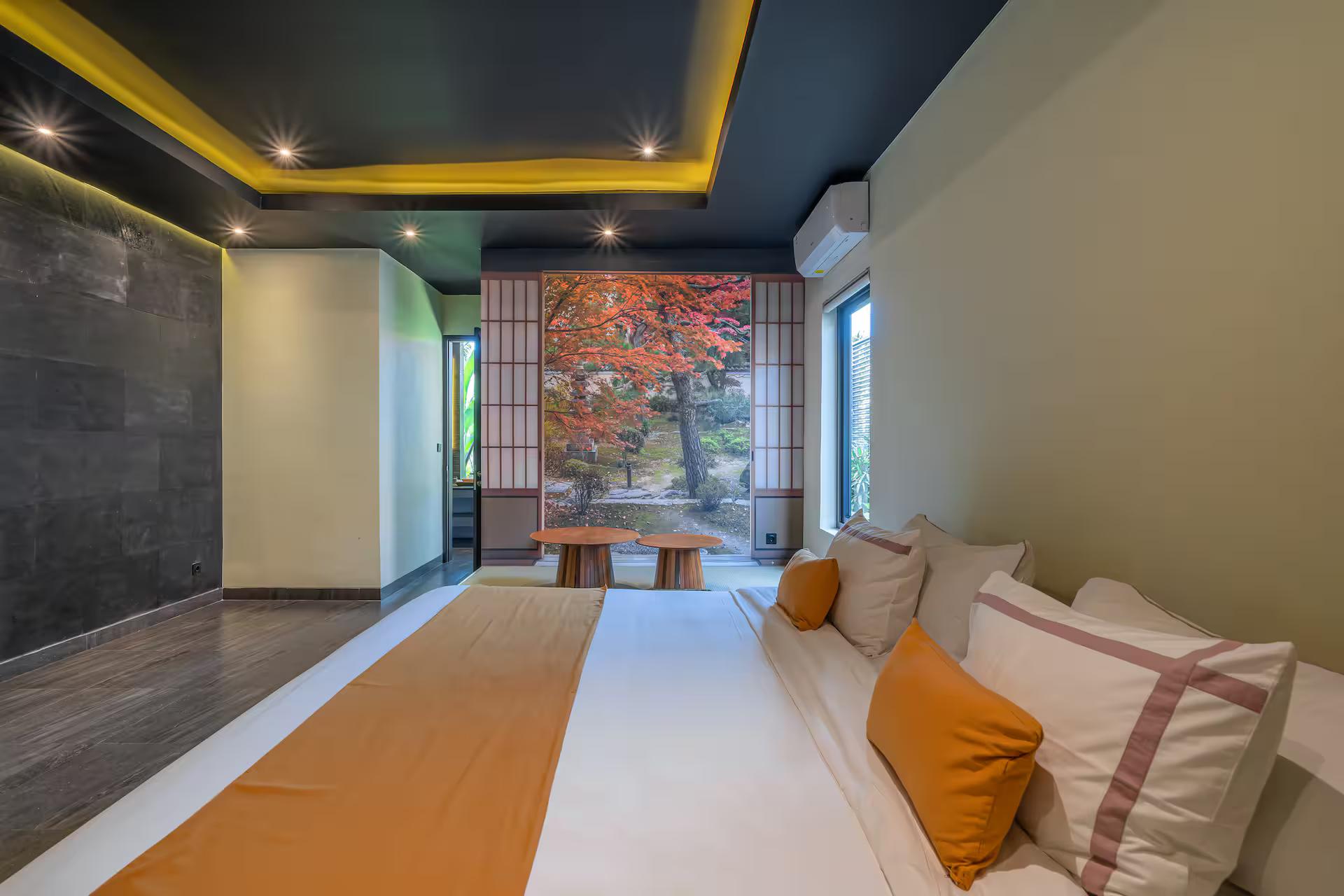 The Japanese room: a raised tatami-style platform behind shoji screens and a red maple panel