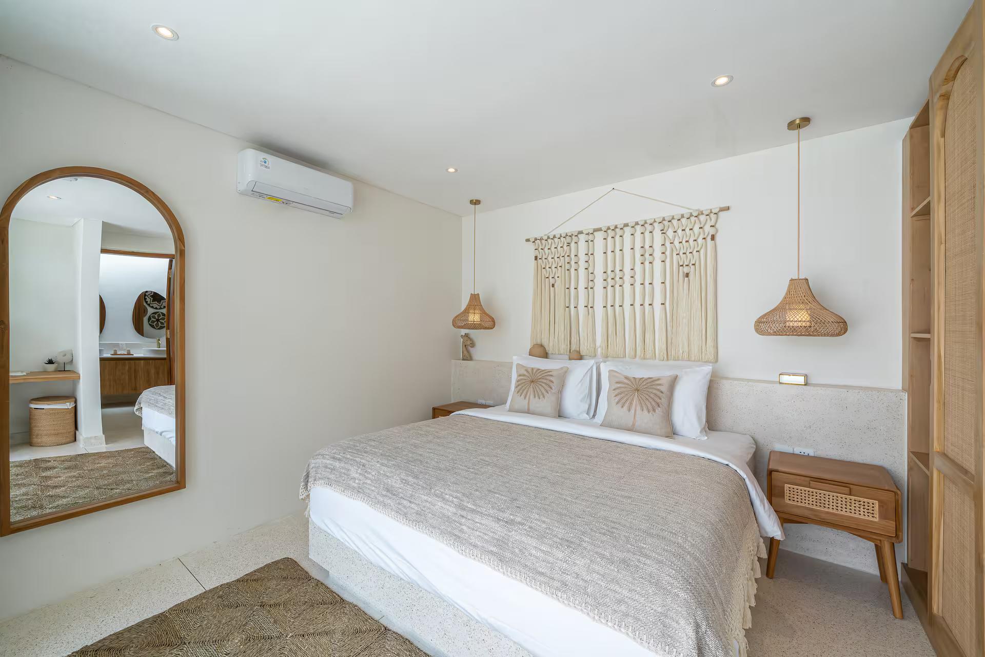 Second king bedroom with an arched full-length mirror and a macrame headboard panel