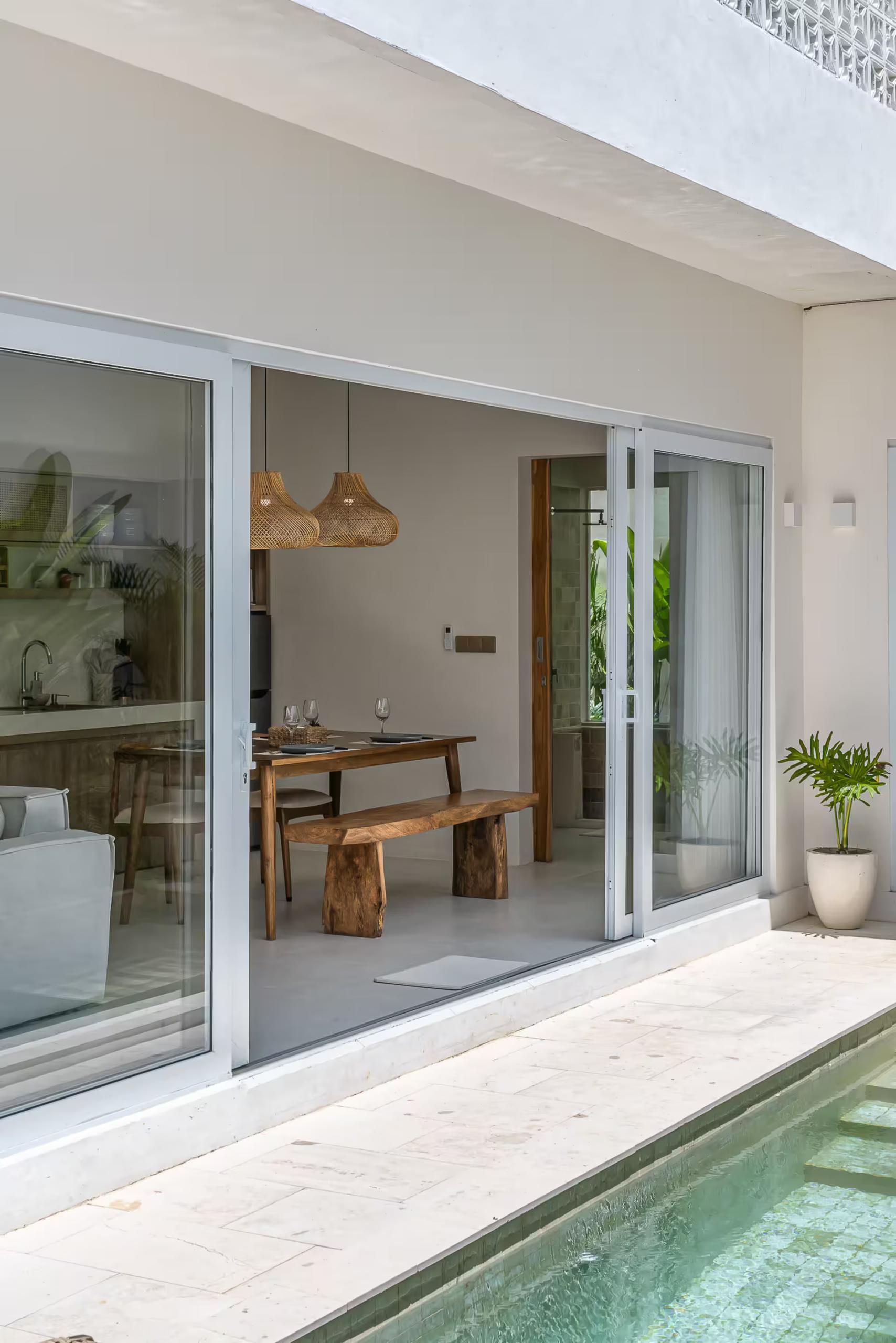 Looking into the living and dining space from the pool terrace at Villa Gajah
